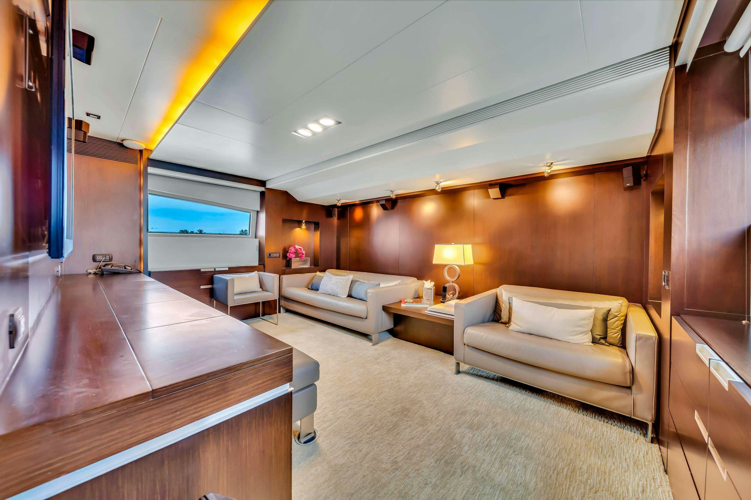 a living room with a couch and a tv aboard RYLAX Yacht for Charter