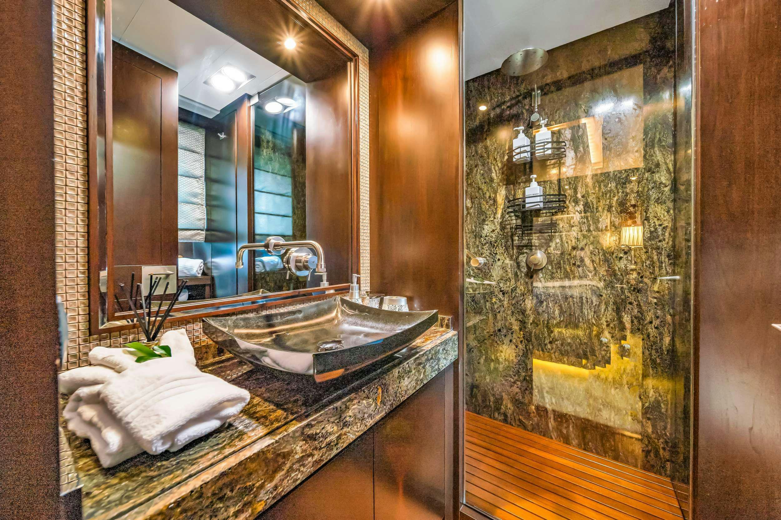 a bathroom with a large mirror aboard RYLAX Yacht for Charter