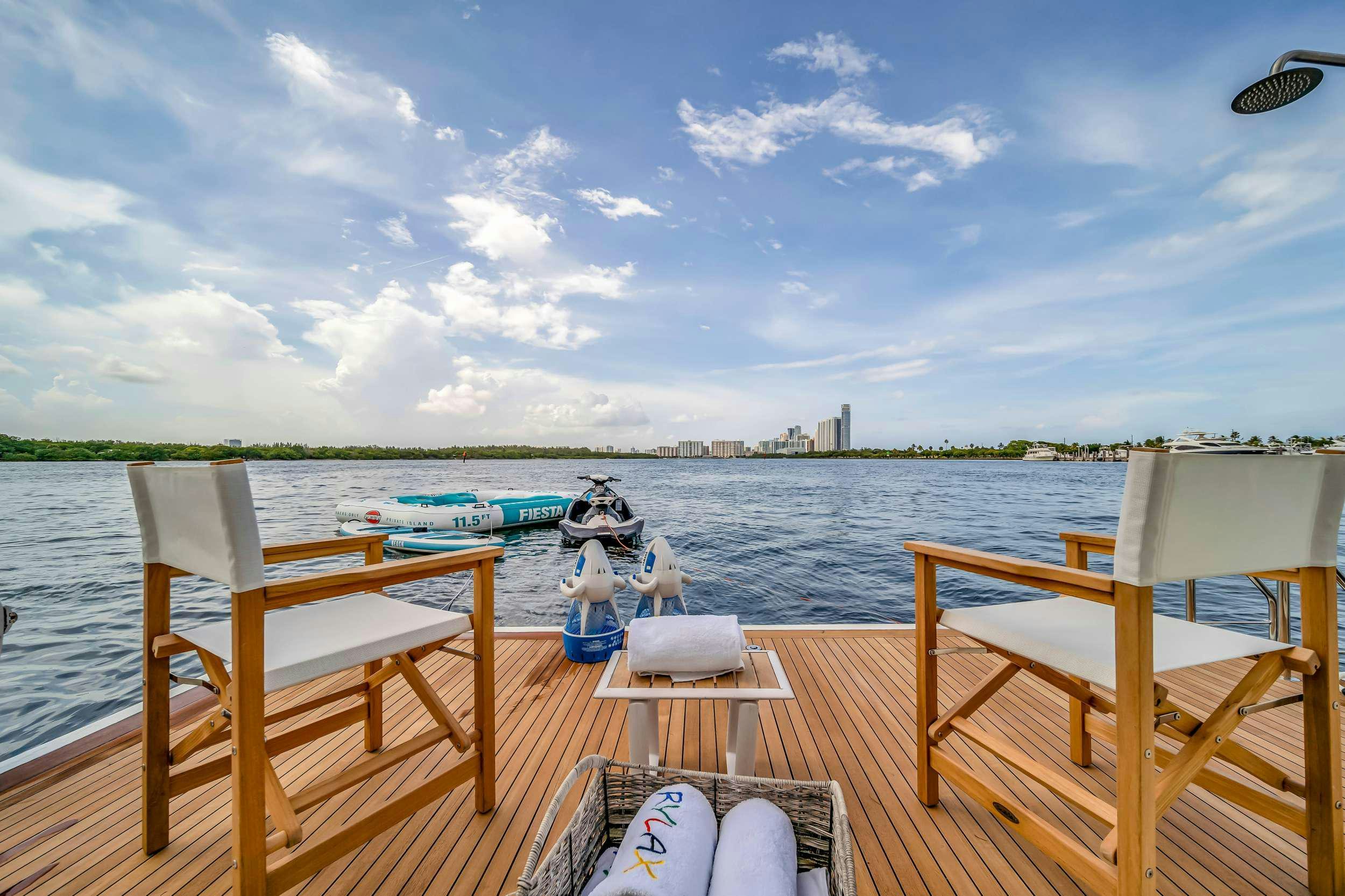 a dock with a boat and people on it aboard RYLAX Yacht for Charter