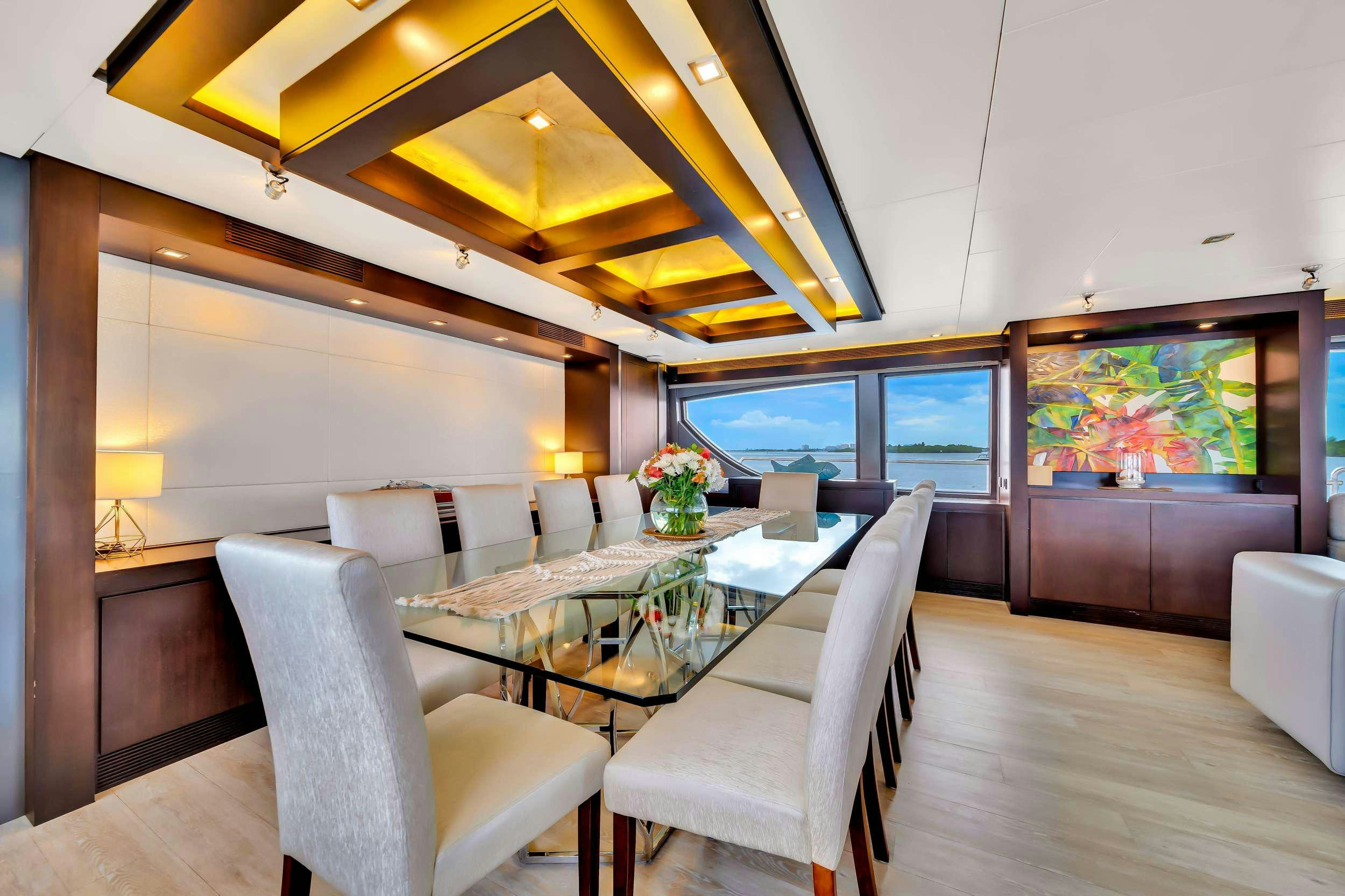a room with a table chairs and a tv aboard RYLAX Yacht for Charter