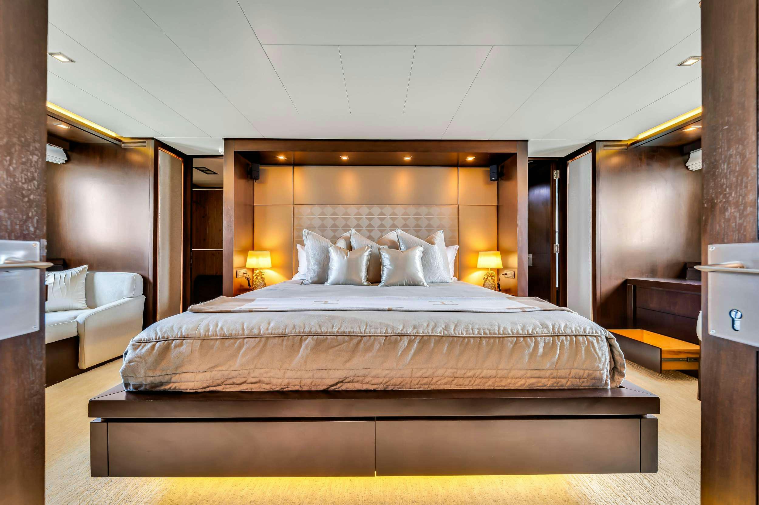 a large bed with a white bed aboard RYLAX Yacht for Charter