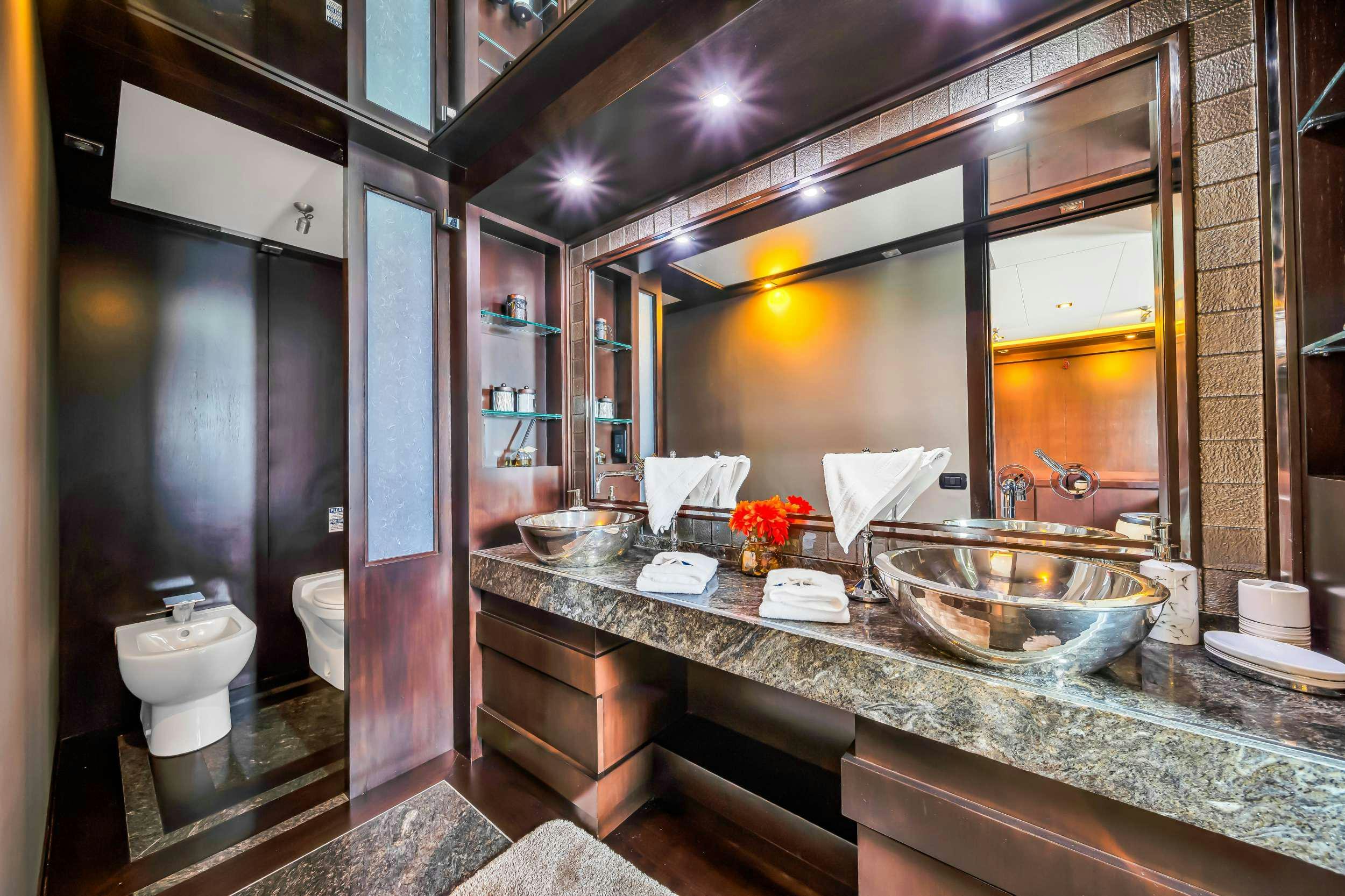 a bathroom with a large mirror aboard RYLAX Yacht for Charter