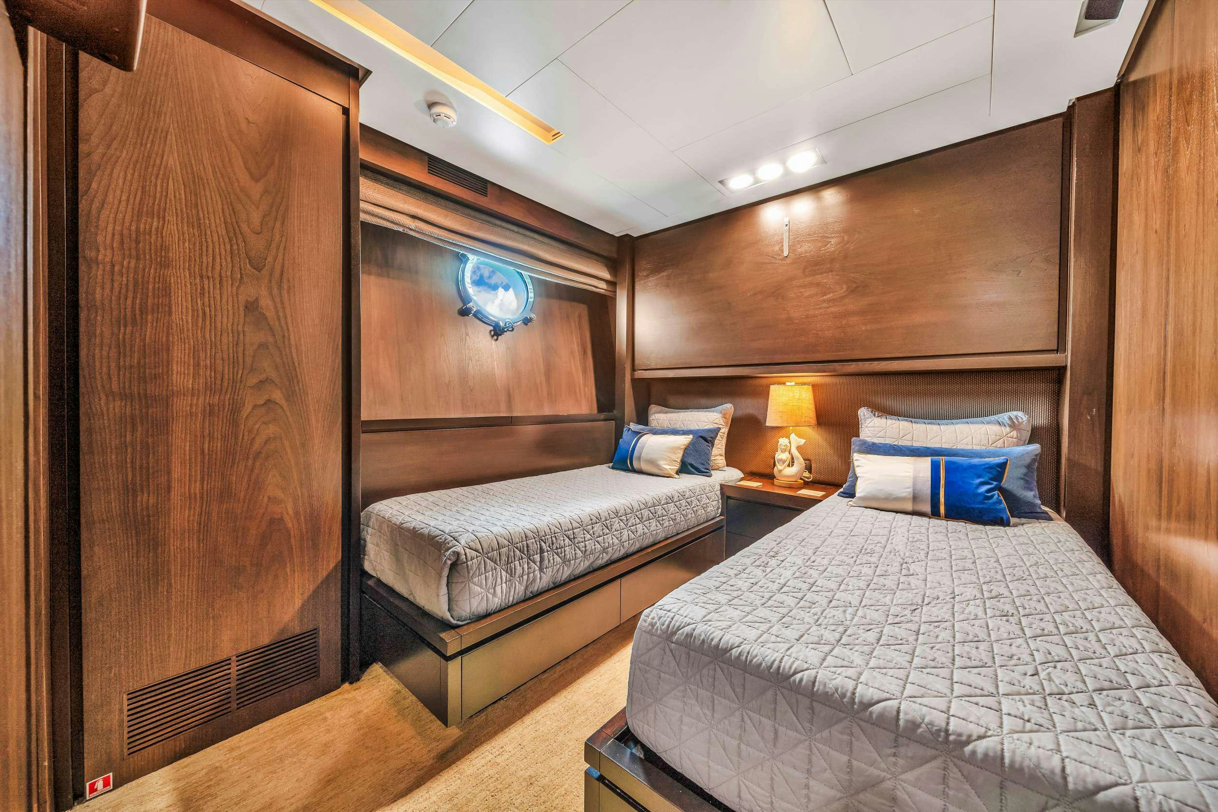 a room with a bed and a wood cabinet aboard RYLAX Yacht for Charter