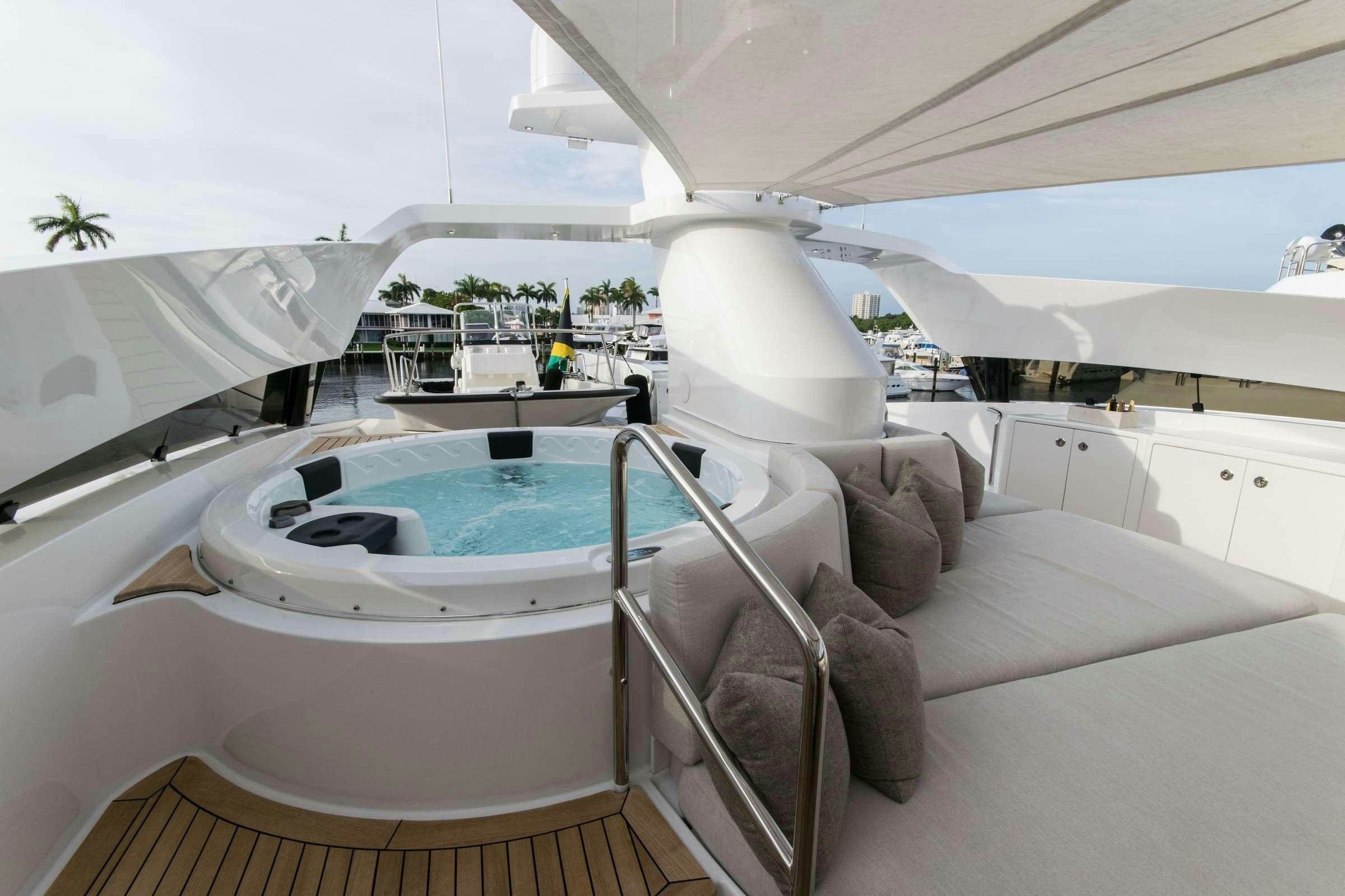 a white lounge chair next to a pool aboard INVICTUS Yacht for Charter