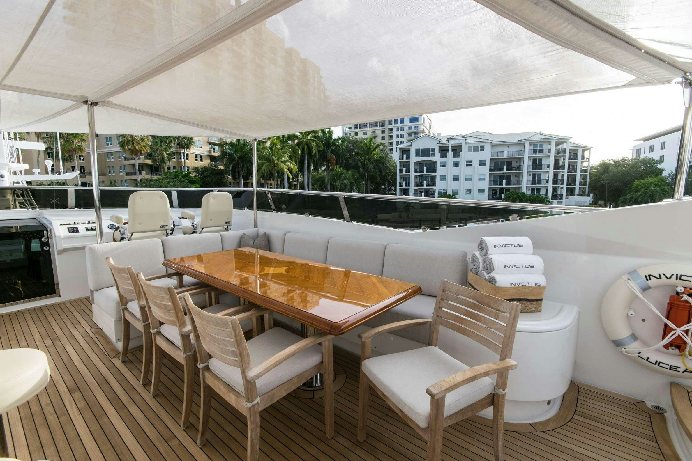a table and chairs on a patio aboard INVICTUS Yacht for Charter