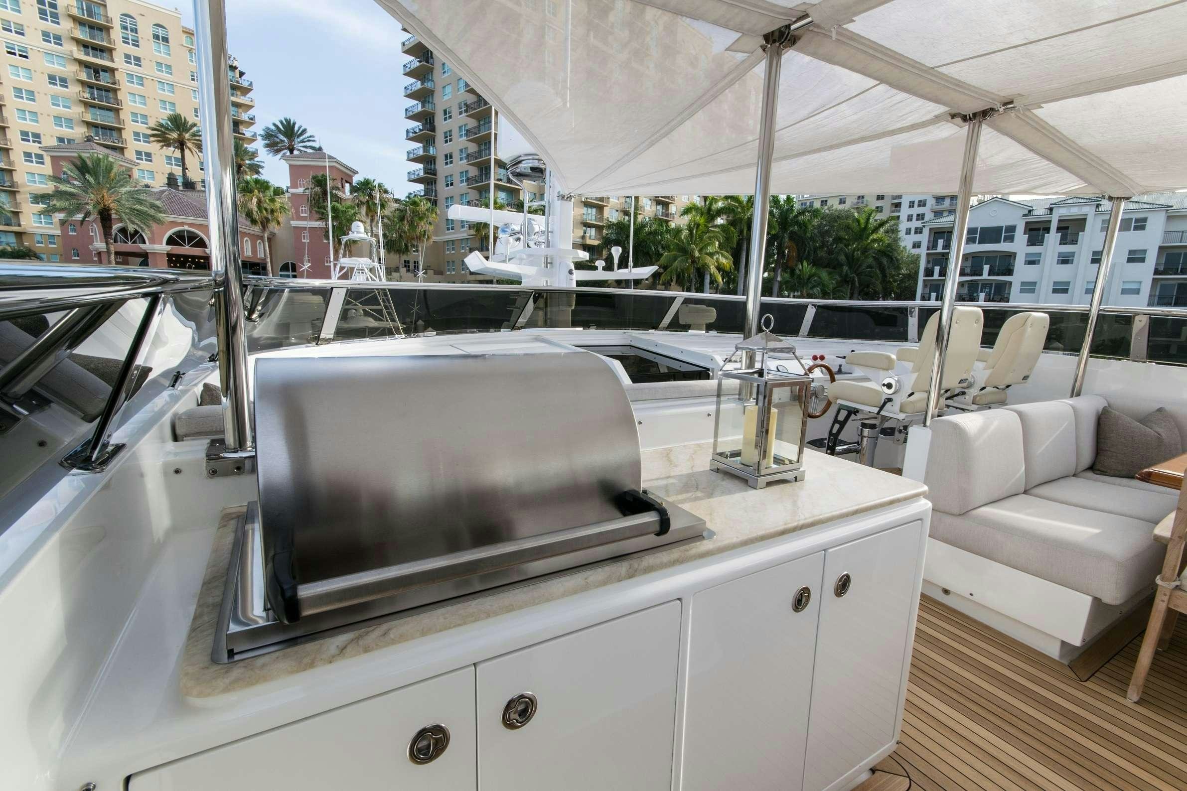 a white kitchen with a television on it aboard INVICTUS Yacht for Charter