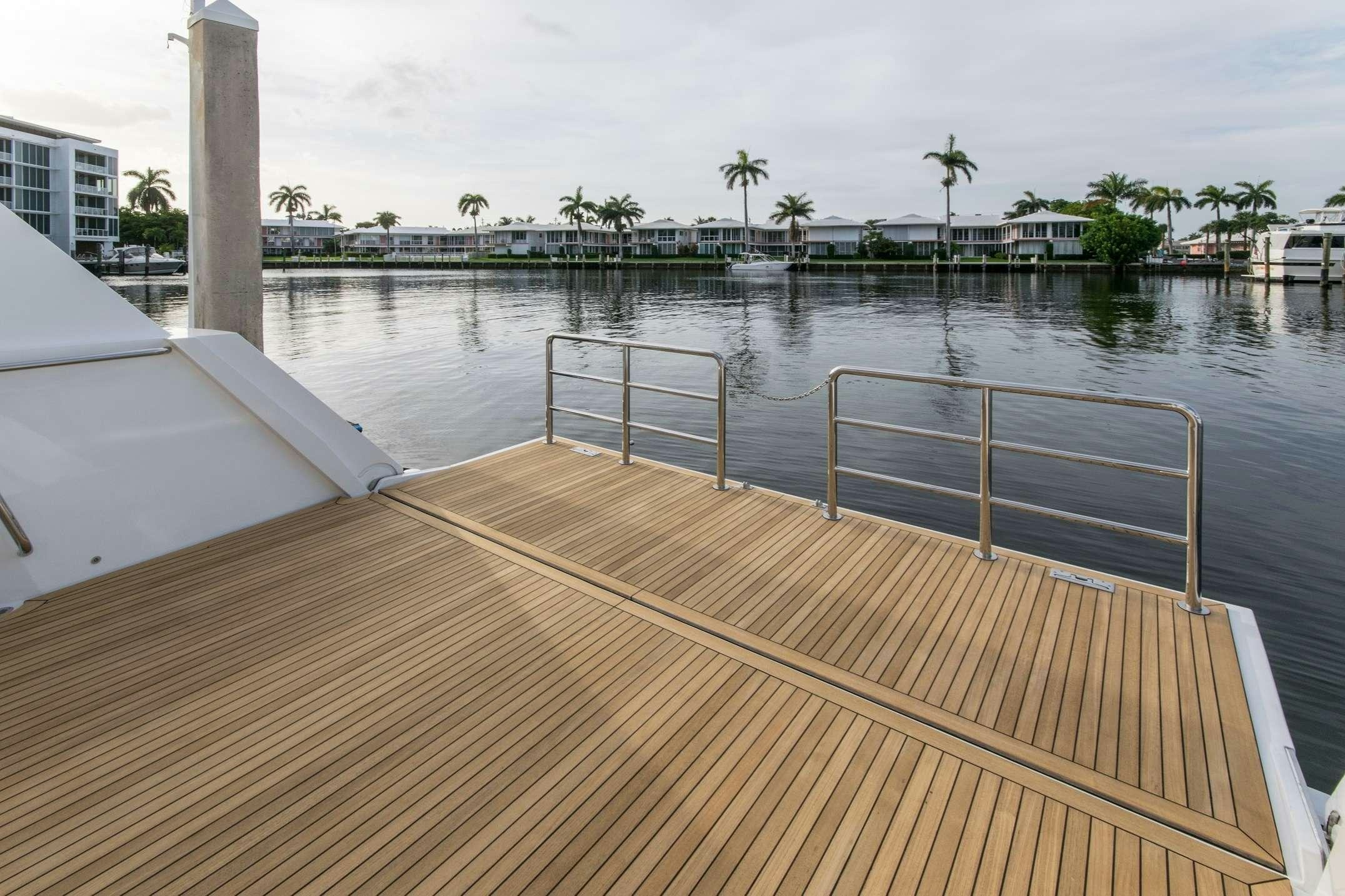 a deck with a railing and water aboard INVICTUS Yacht for Charter