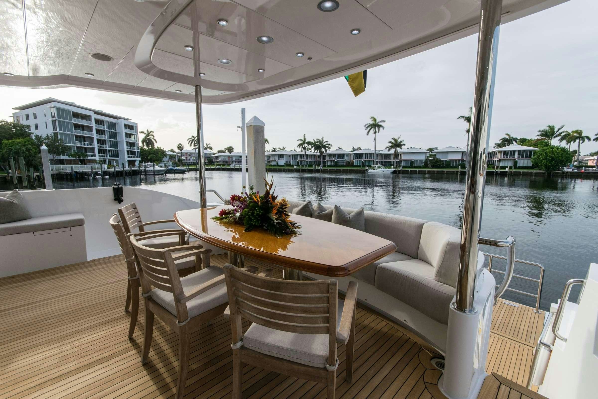 a table and chairs on a deck aboard INVICTUS Yacht for Charter