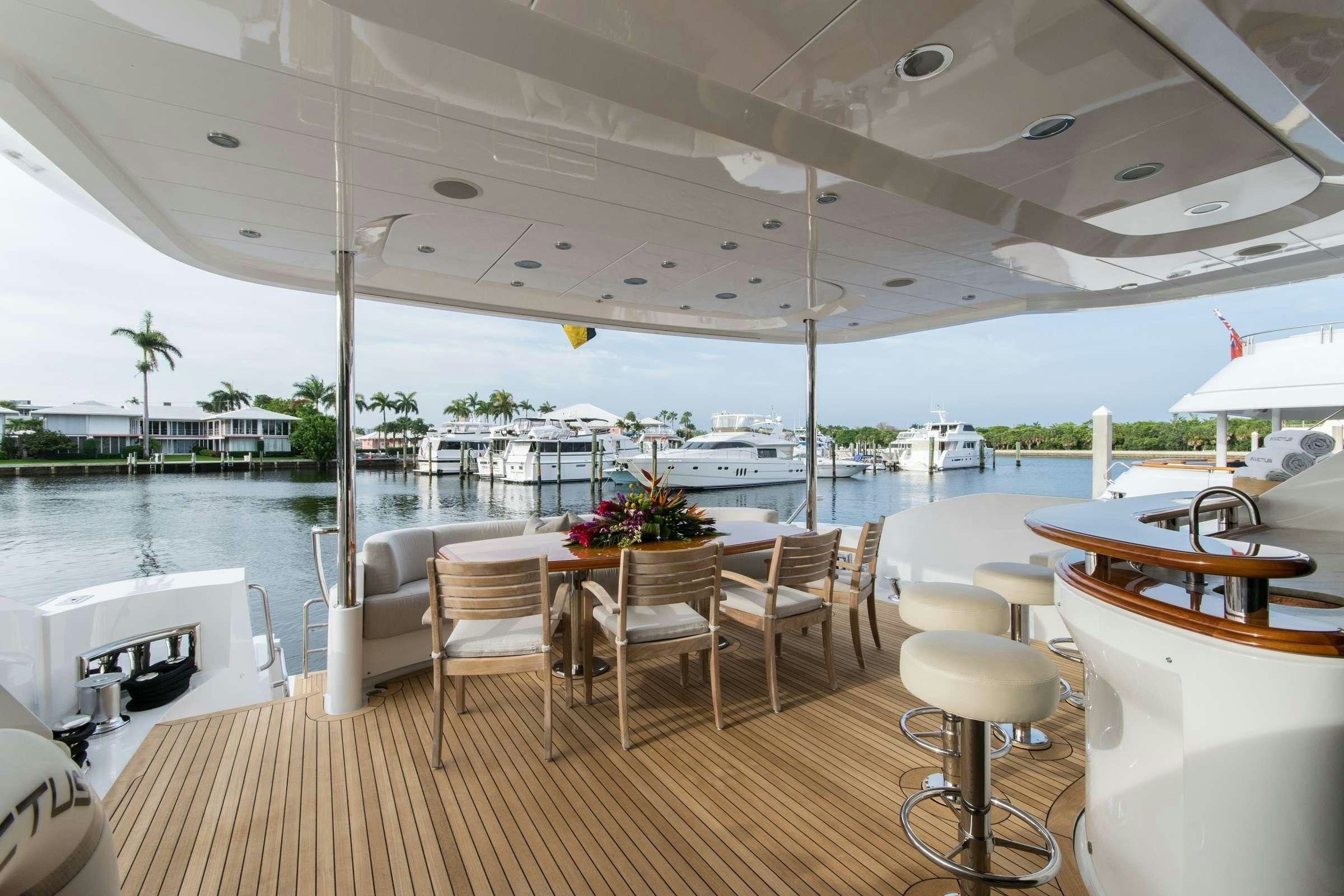 a room with tables and chairs aboard INVICTUS Yacht for Charter