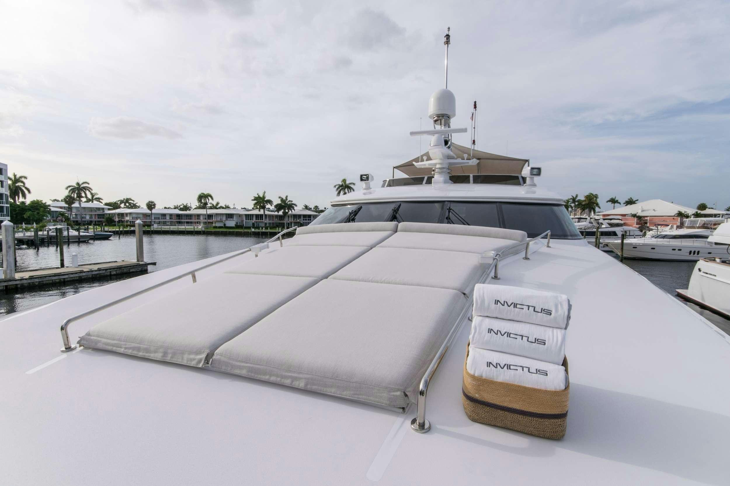 a boat with a white sail aboard INVICTUS Yacht for Charter