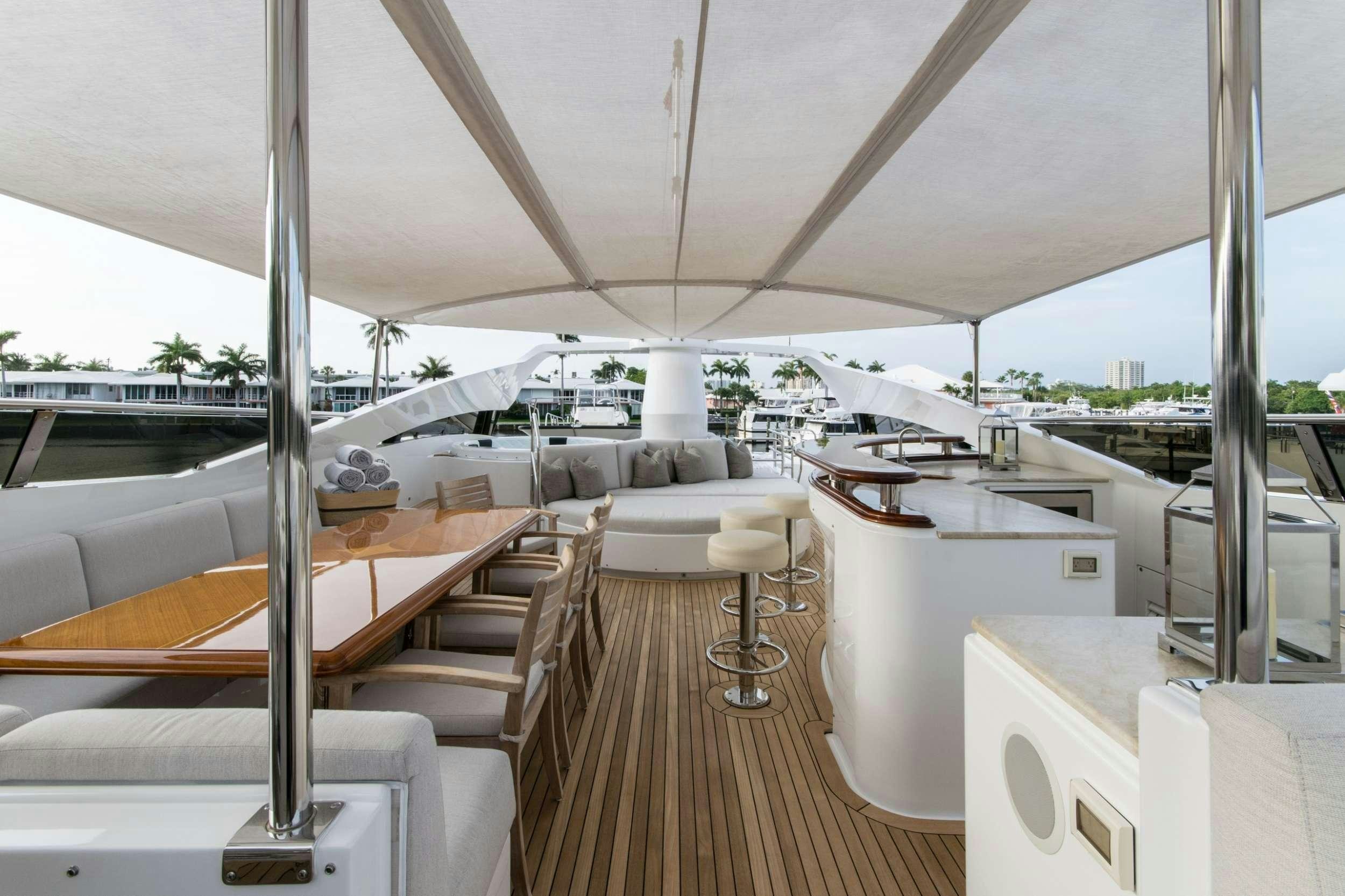 a room with a couch and a table and a large window aboard INVICTUS Yacht for Charter