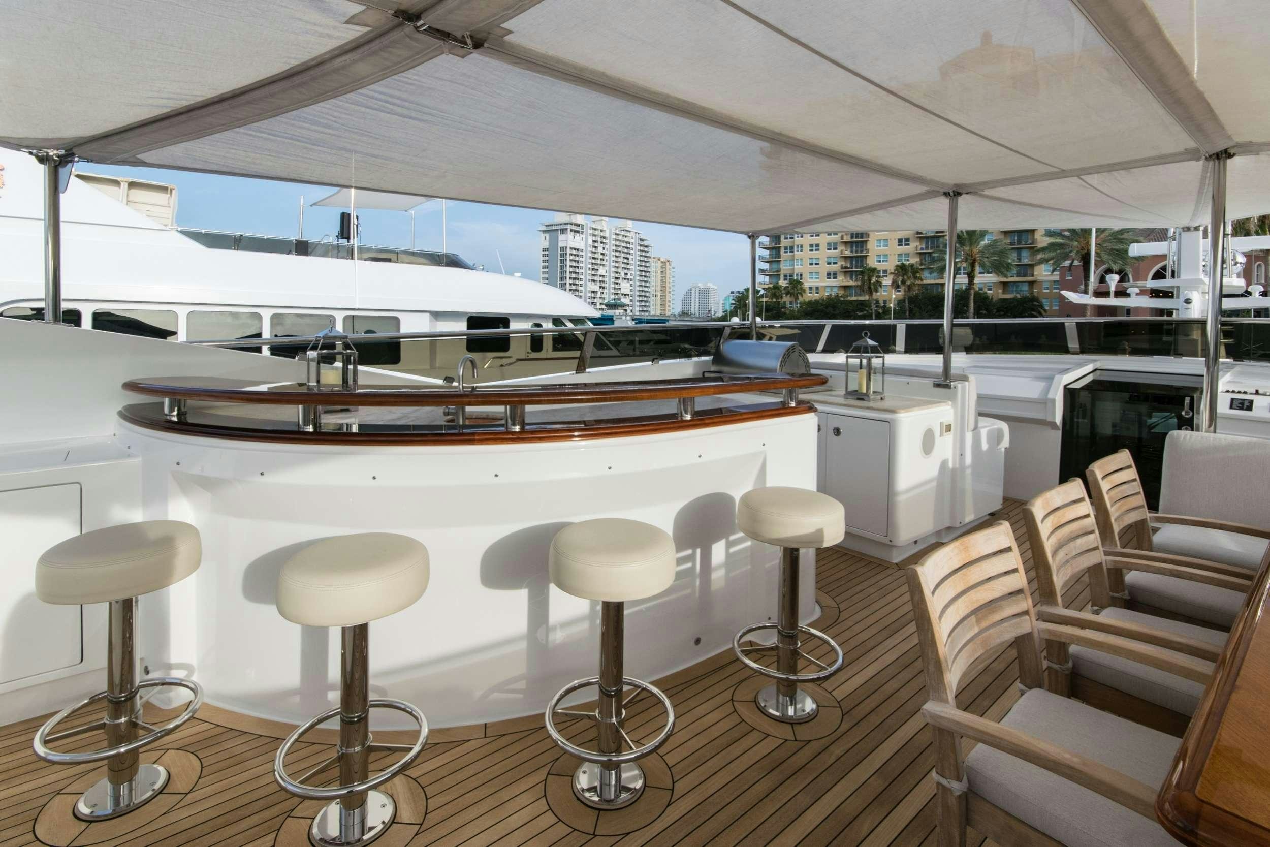 a large kitchen with stools aboard INVICTUS Yacht for Charter