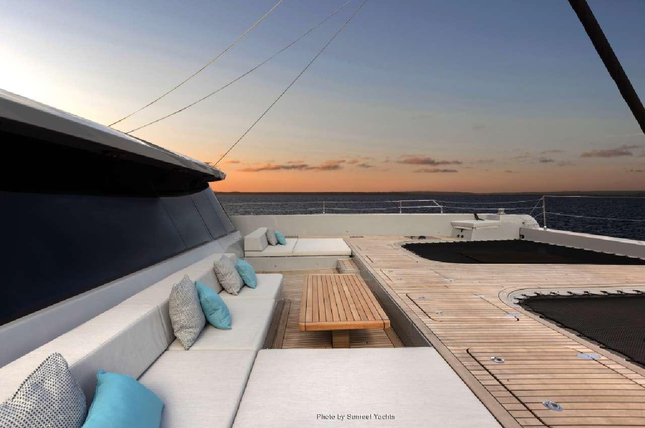 a deck with a view of the ocean and the sunset aboard SHADES OF GREY Yacht for Charter