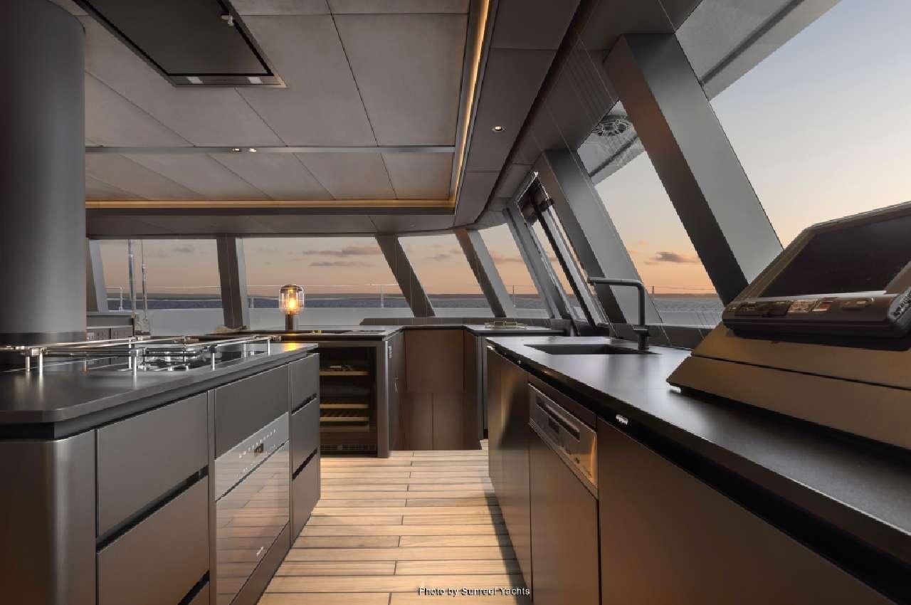a kitchen with a large island aboard SHADES OF GREY Yacht for Charter