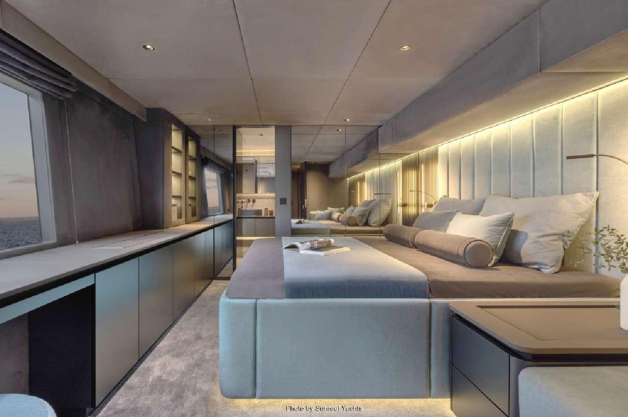 a room with a bed and a desk aboard SHADES OF GREY Yacht for Charter