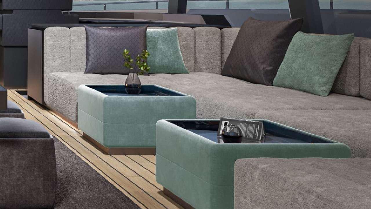 a couch with pillows and a coffee table aboard SHADES OF GREY Yacht for Charter