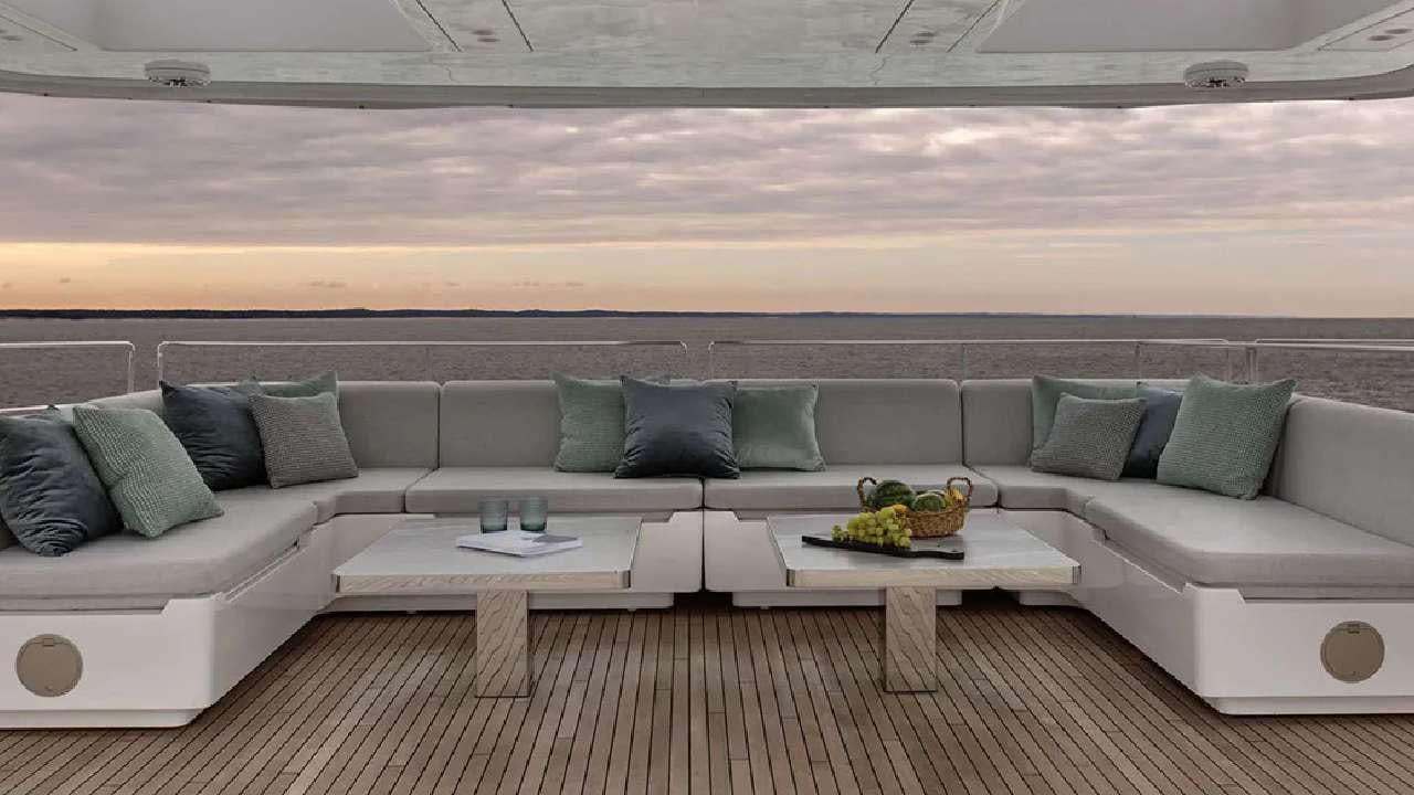 a couch with pillows and a table aboard SHADES OF GREY Yacht for Charter