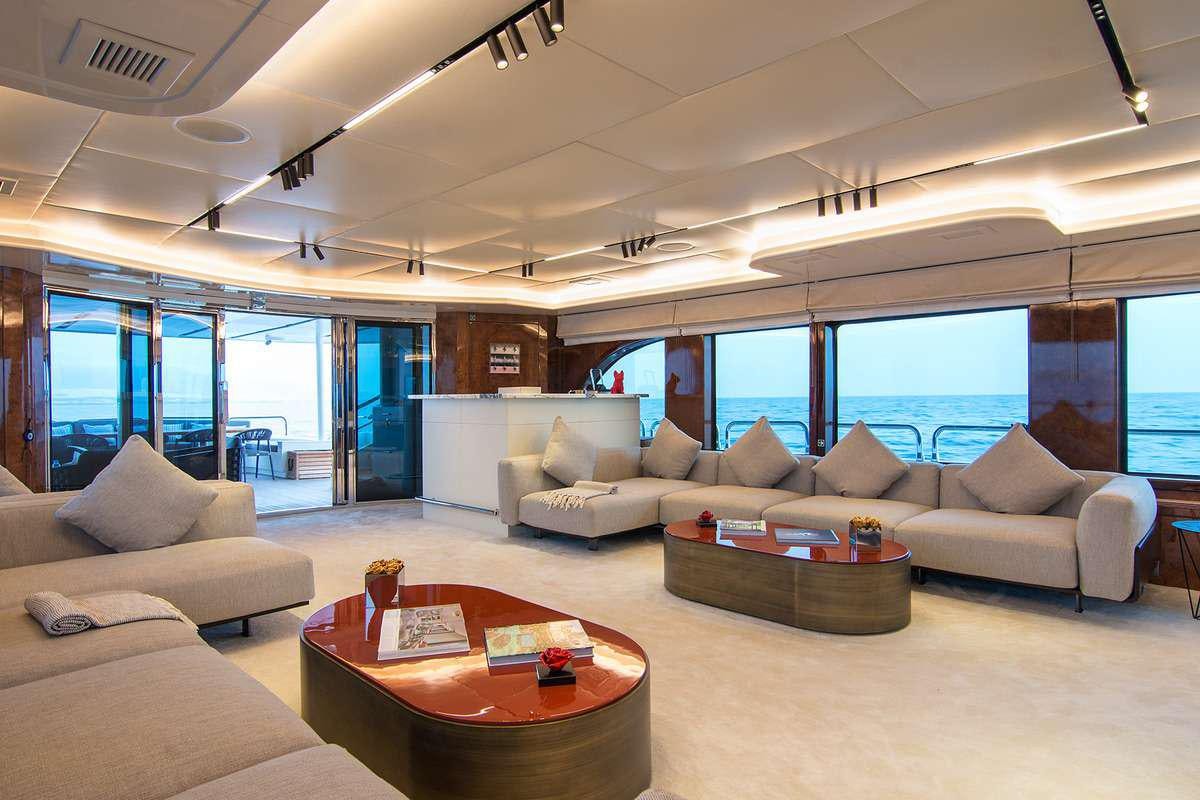 a living room with a large window aboard MOKA Yacht for Charter