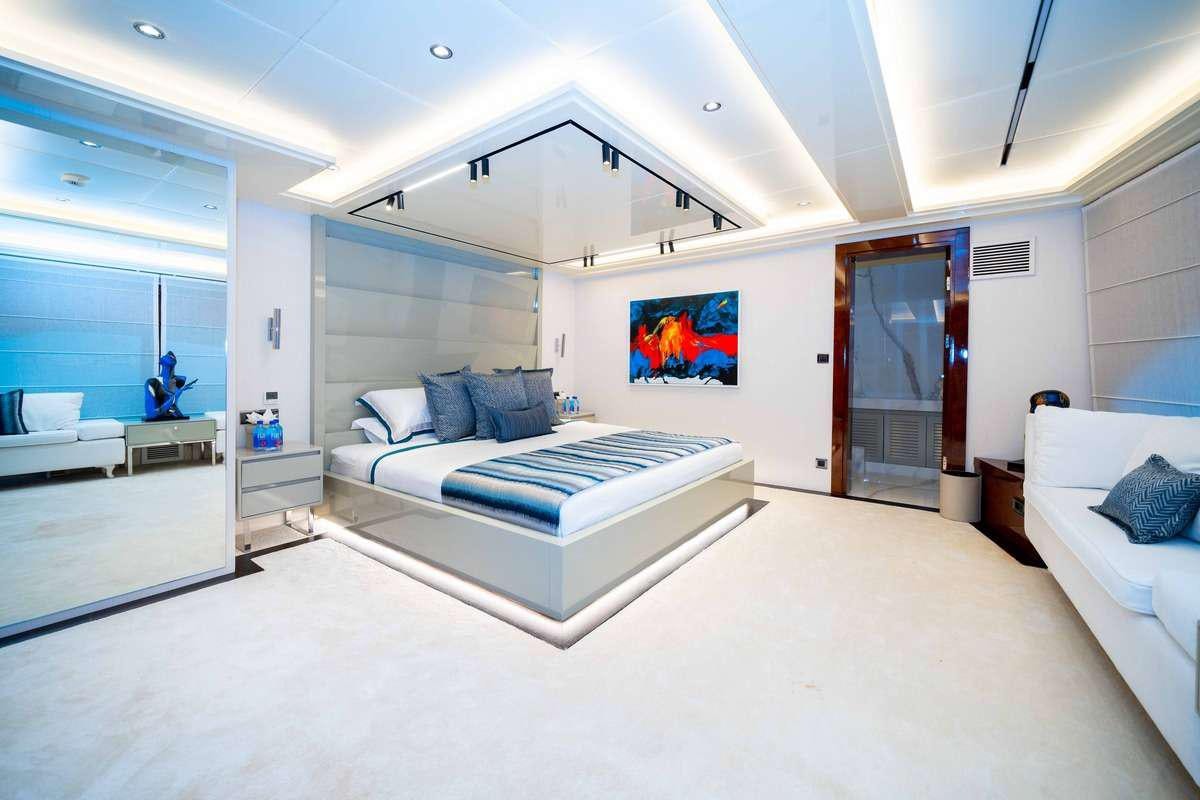 a room with a bed and a couch aboard MOKA Yacht for Charter
