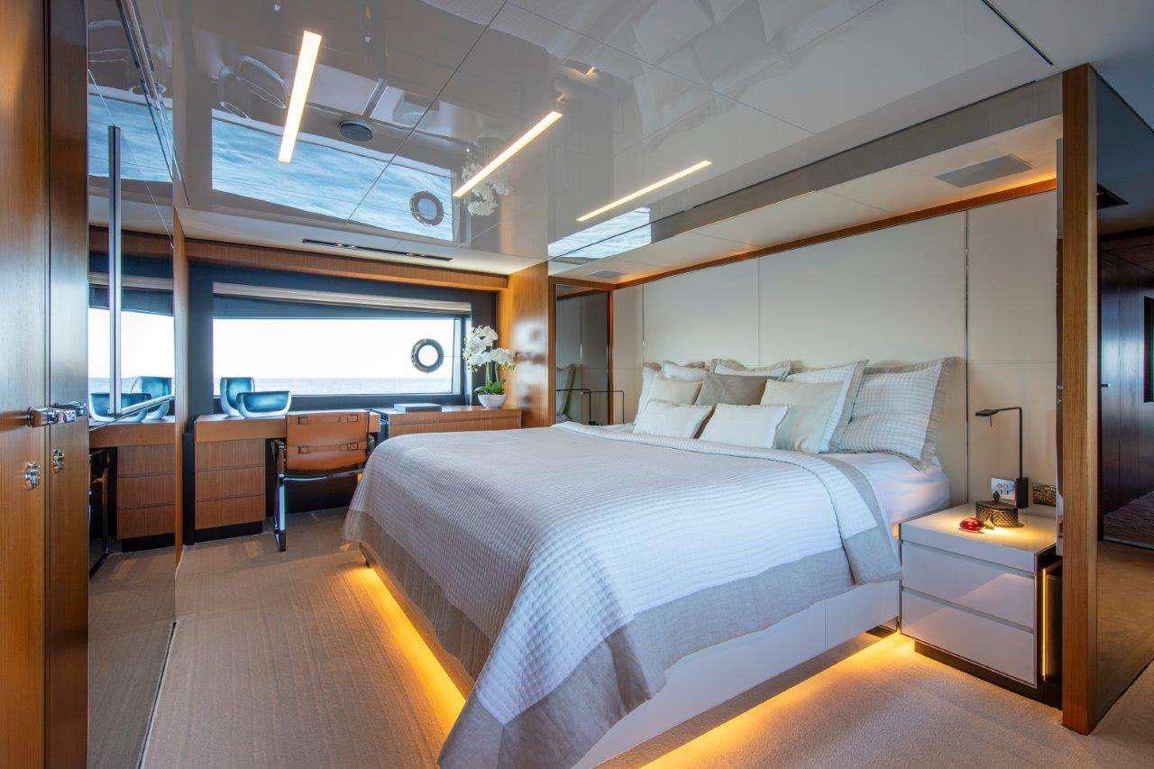 a room with a bed and a desk aboard NO STRESS 888 Yacht for Charter