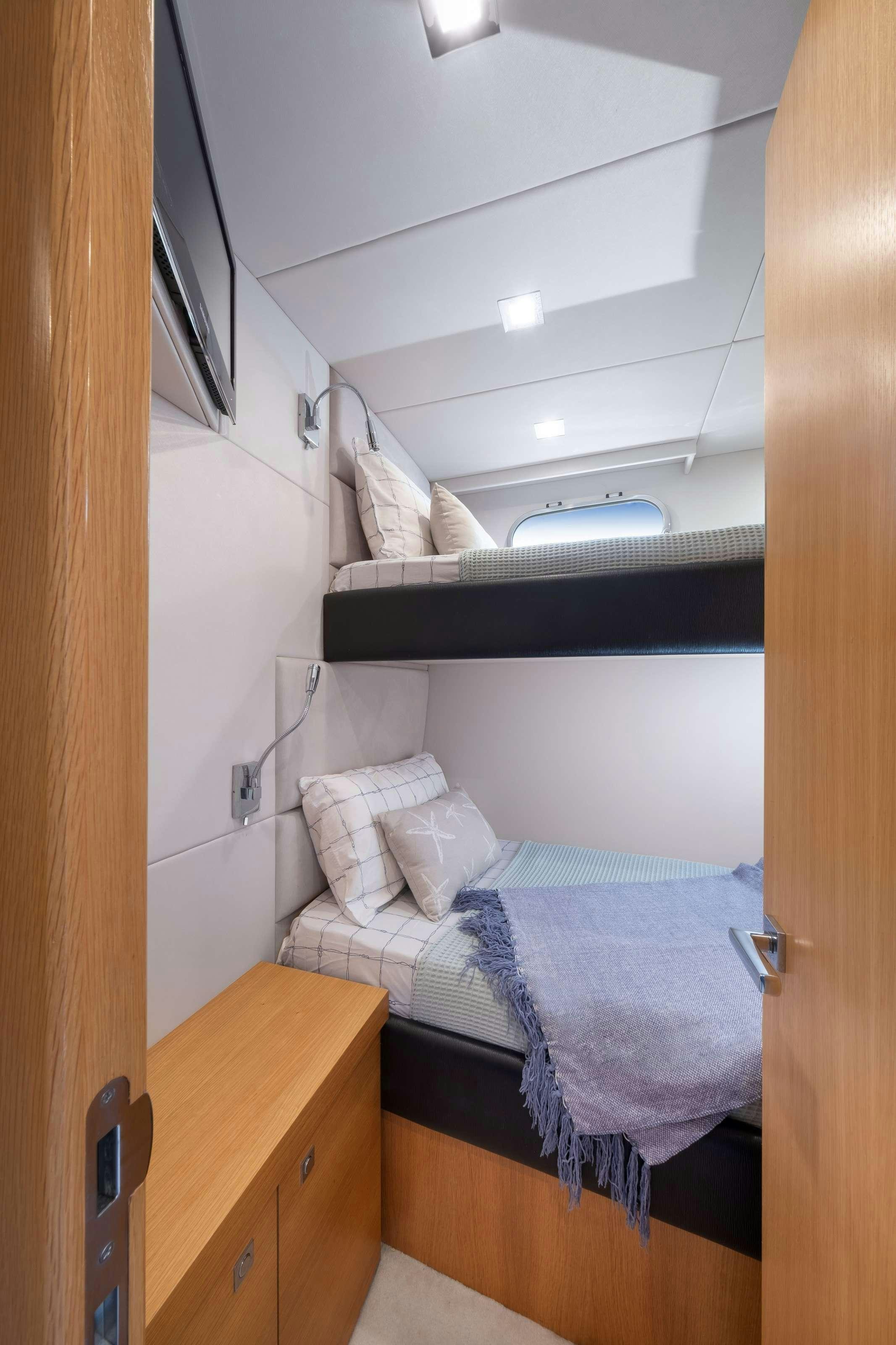 a room with a bed and a desk aboard POLPO Yacht for Charter