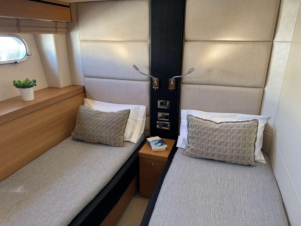 a bed with a pillow and a lamp on it aboard POLPO Yacht for Charter