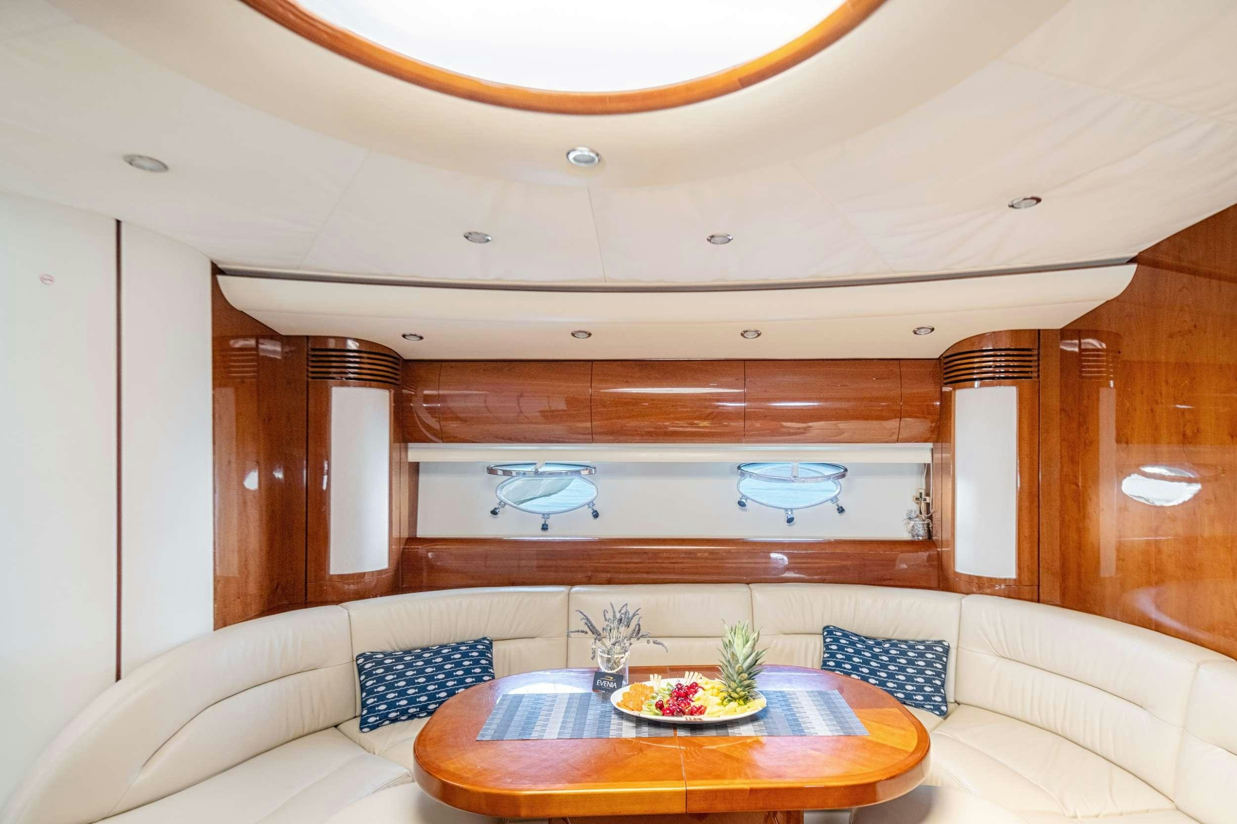 a room with a couch and a table aboard EVENIA Yacht for Charter