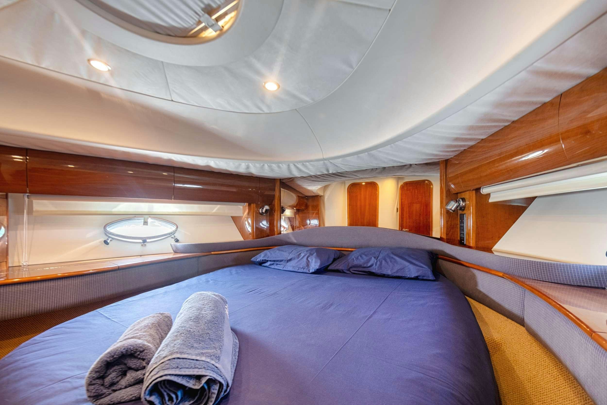 a room with a bed and a window aboard EVENIA Yacht for Charter