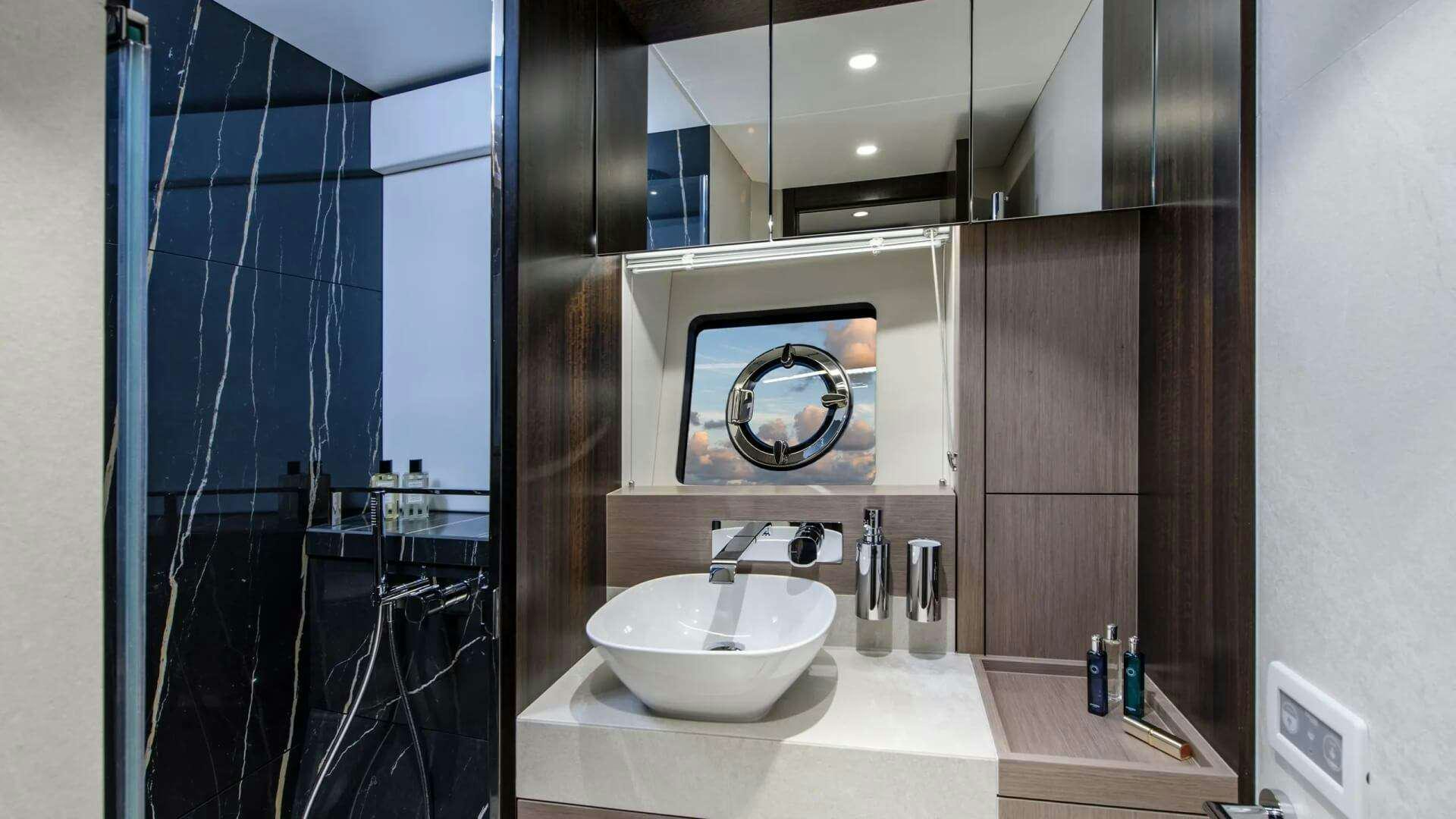 a bathroom with a sink and a mirror aboard APOLLO Yacht for Charter