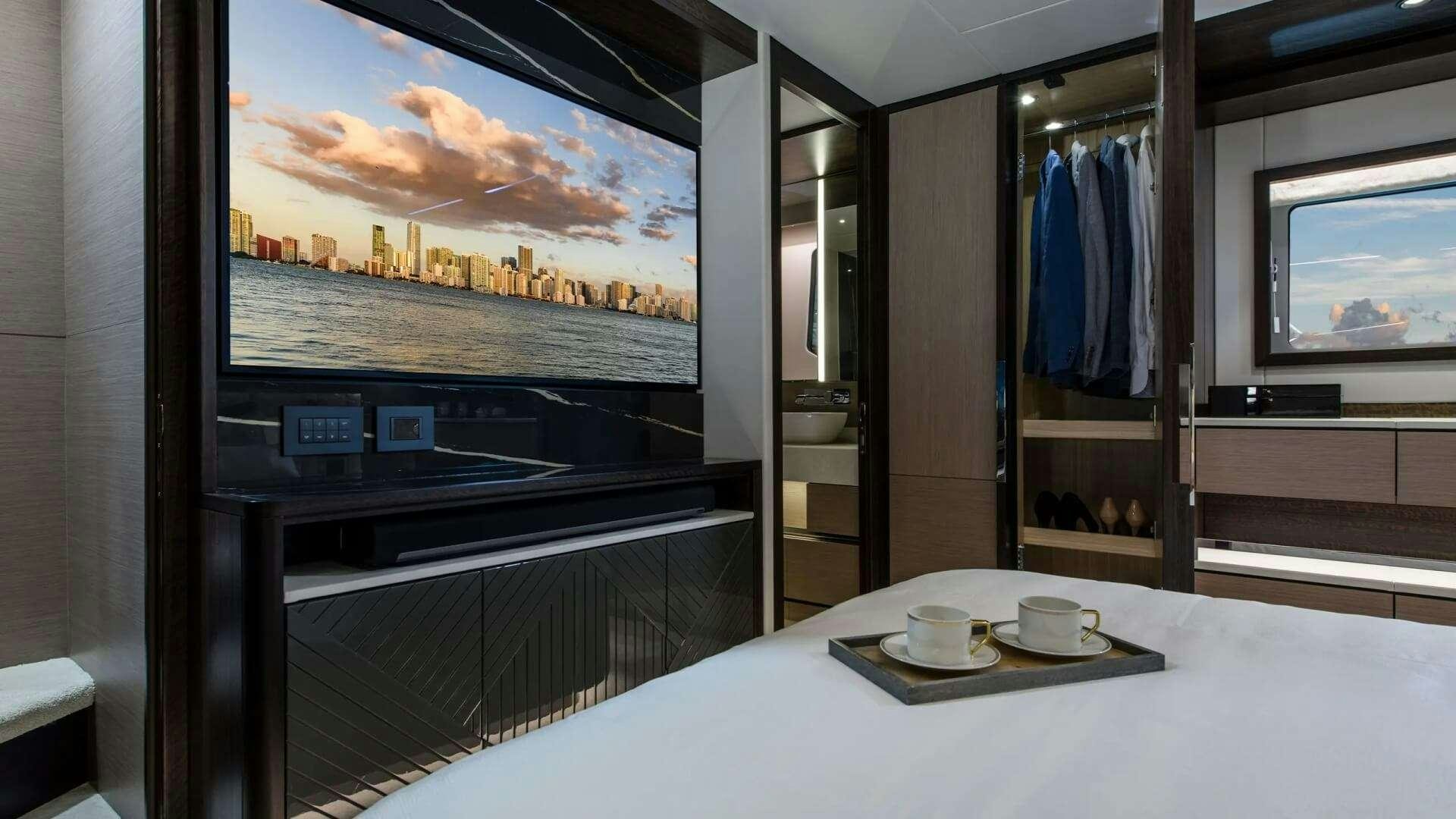 a room with a large window and a table with a plate of food aboard APOLLO Yacht for Charter