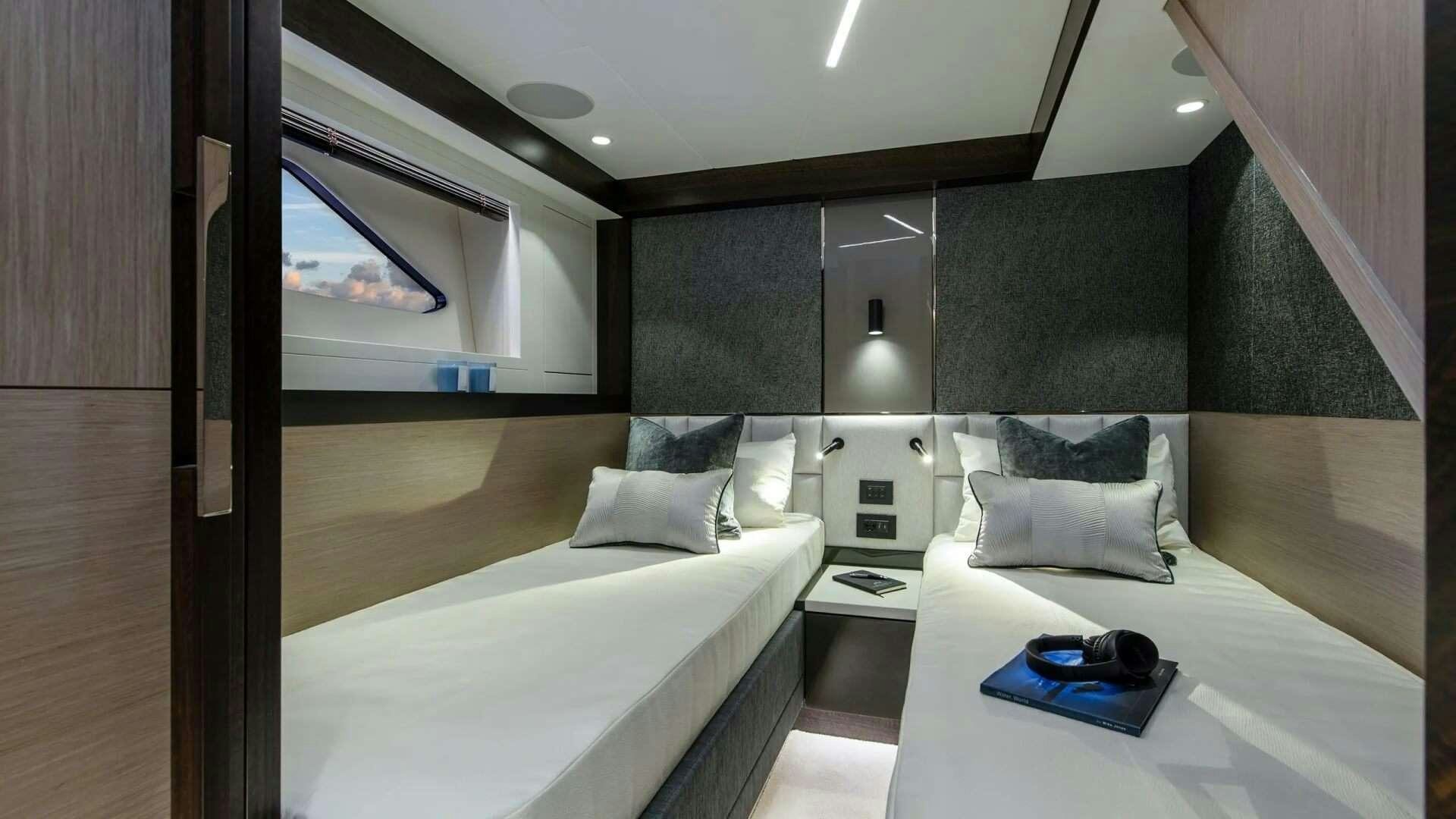 a room with a bed and a desk aboard APOLLO Yacht for Charter