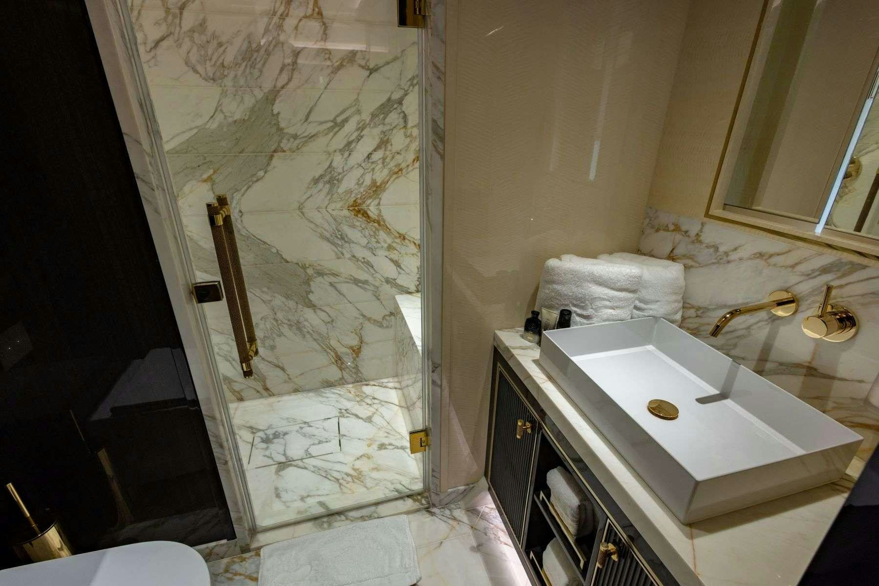 a bathroom with a sink and a mirror aboard OLYMPUS Yacht for Charter