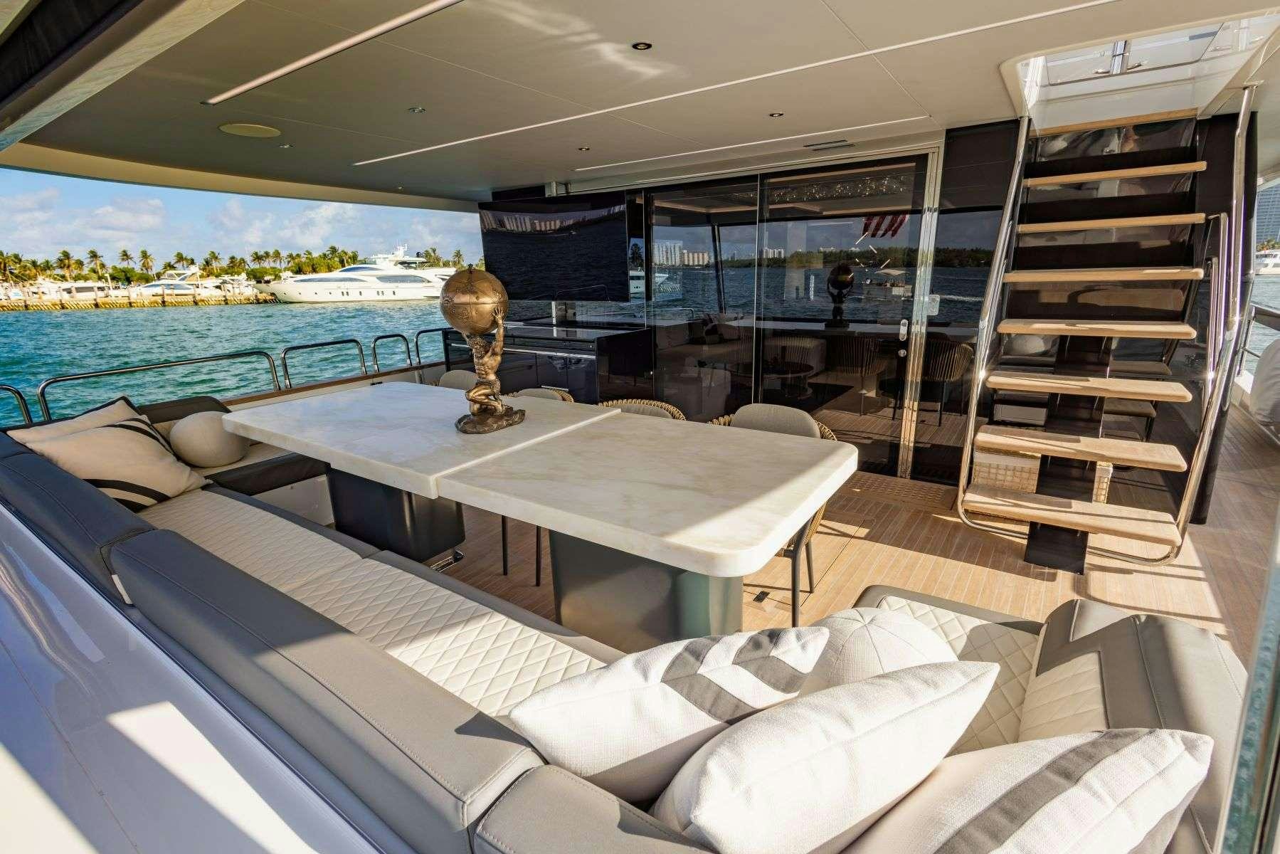a room with a table and a couch aboard OLYMPUS Yacht for Charter