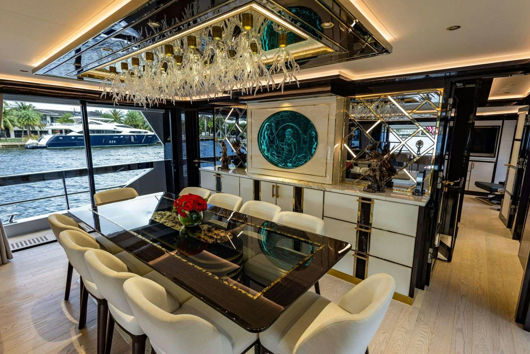 a dining room with a large chandelier aboard OLYMPUS Yacht for Charter