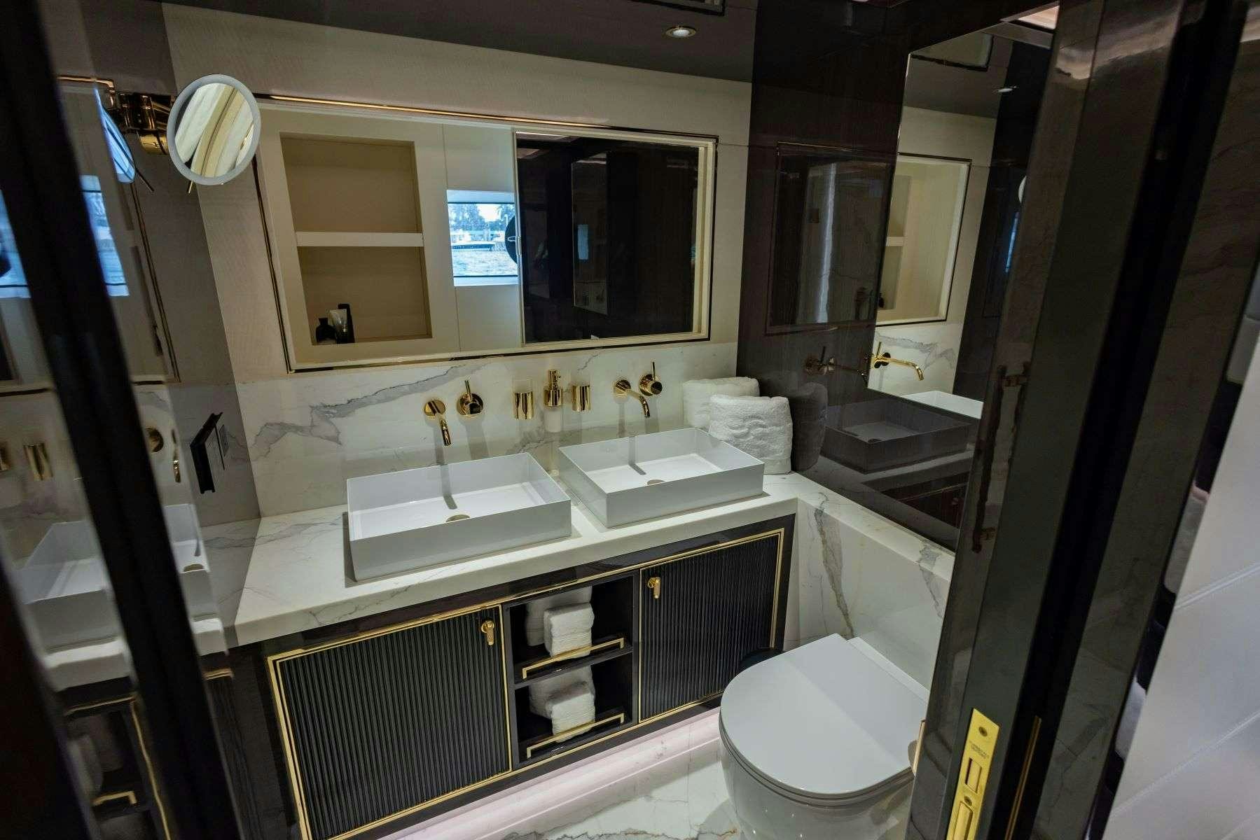 a bathroom with a large mirror aboard OLYMPUS Yacht for Charter