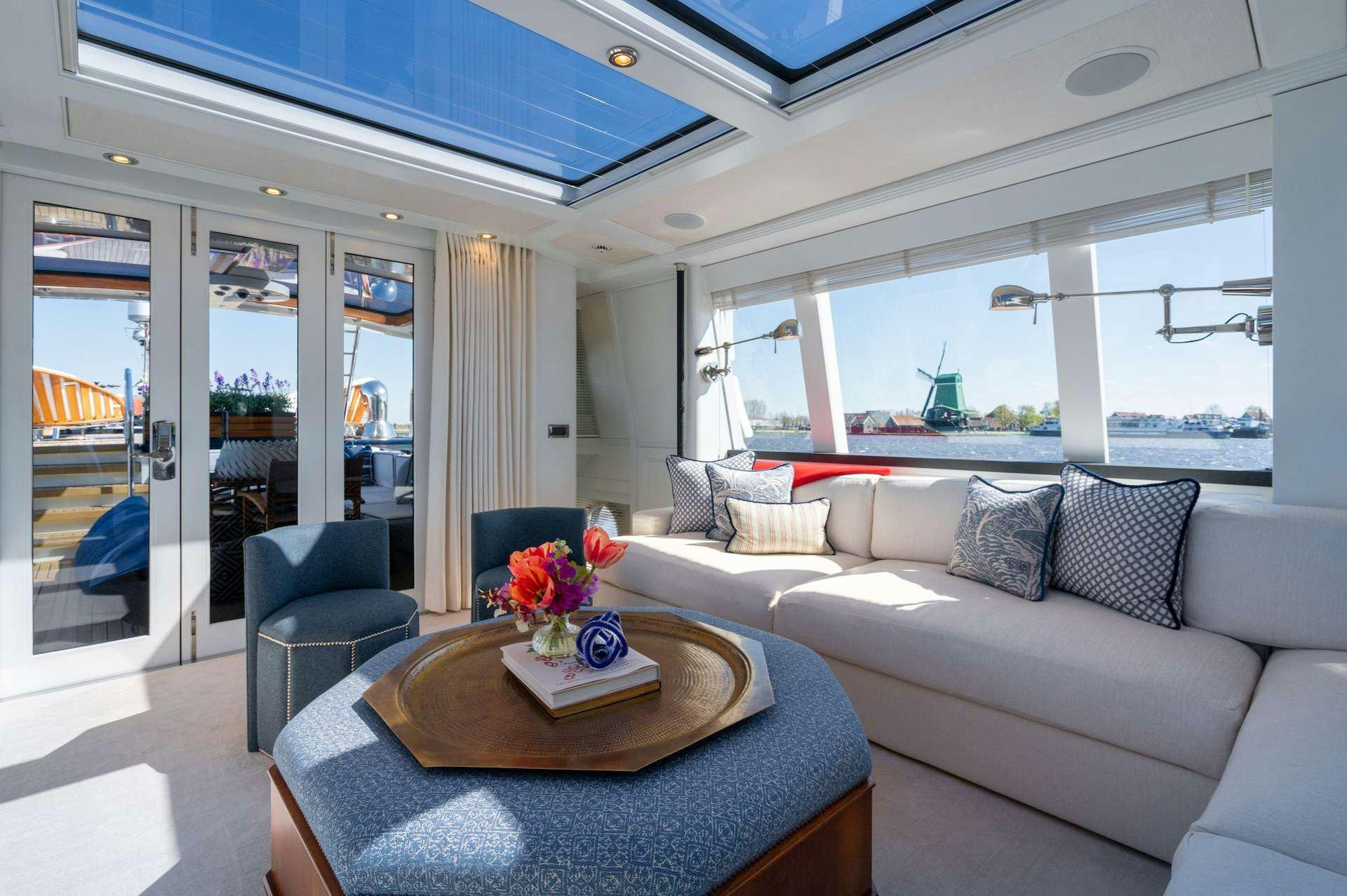 a living room with a couch and a table aboard WONDERLAND Yacht for Charter