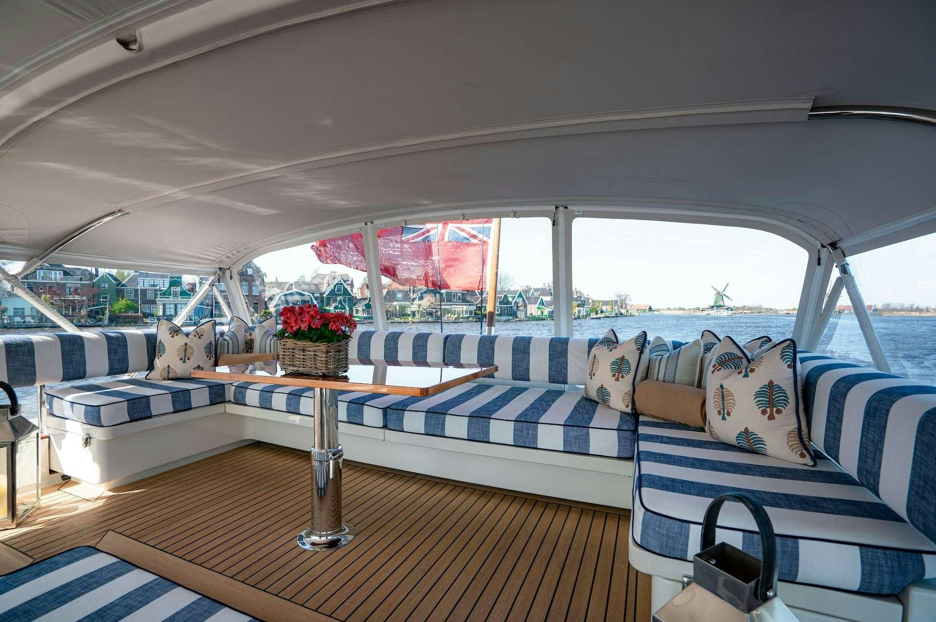 a room with a bed and a table aboard WONDERLAND Yacht for Charter