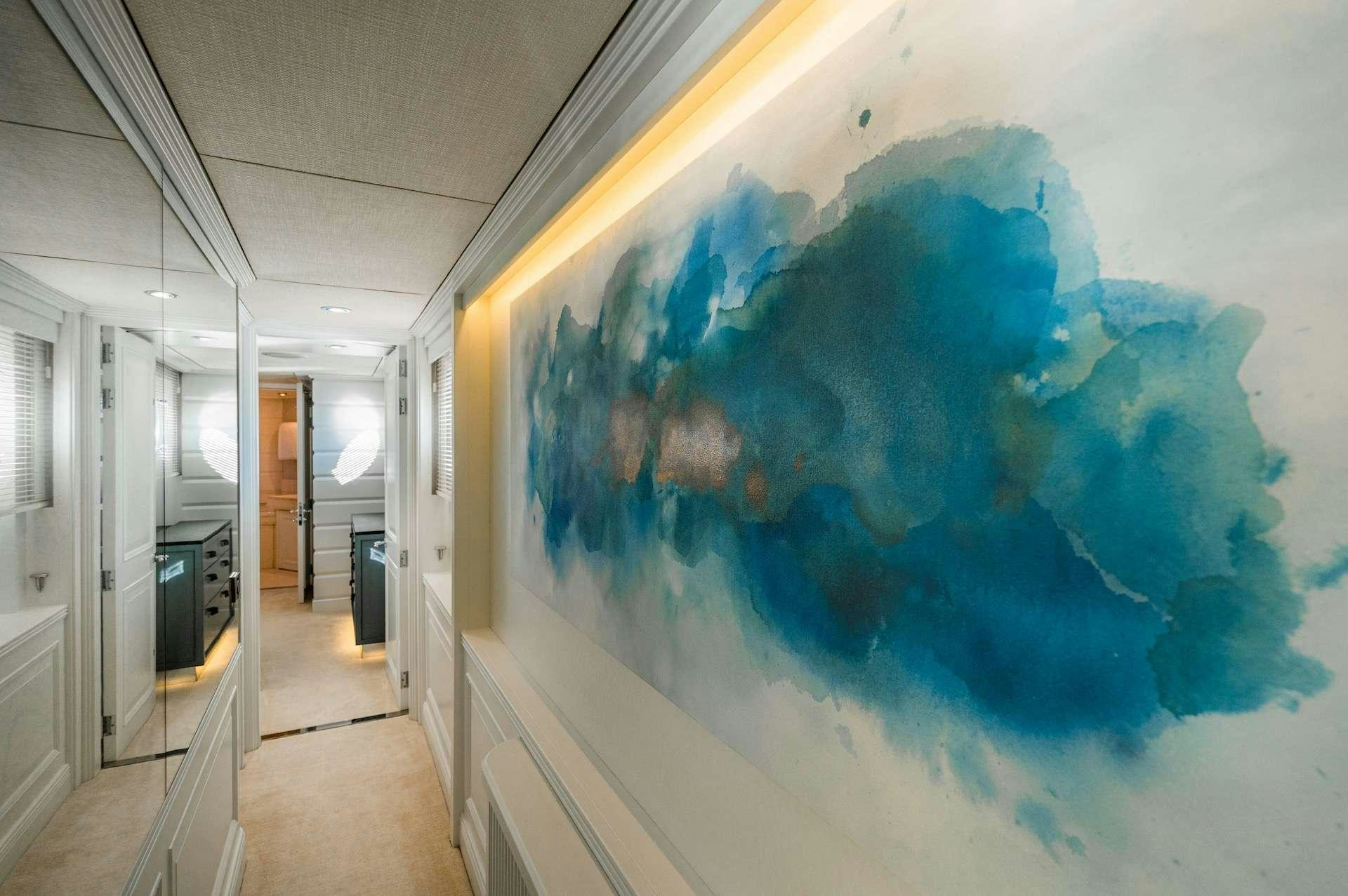 a large blue world map in a hallway aboard WONDERLAND Yacht for Charter