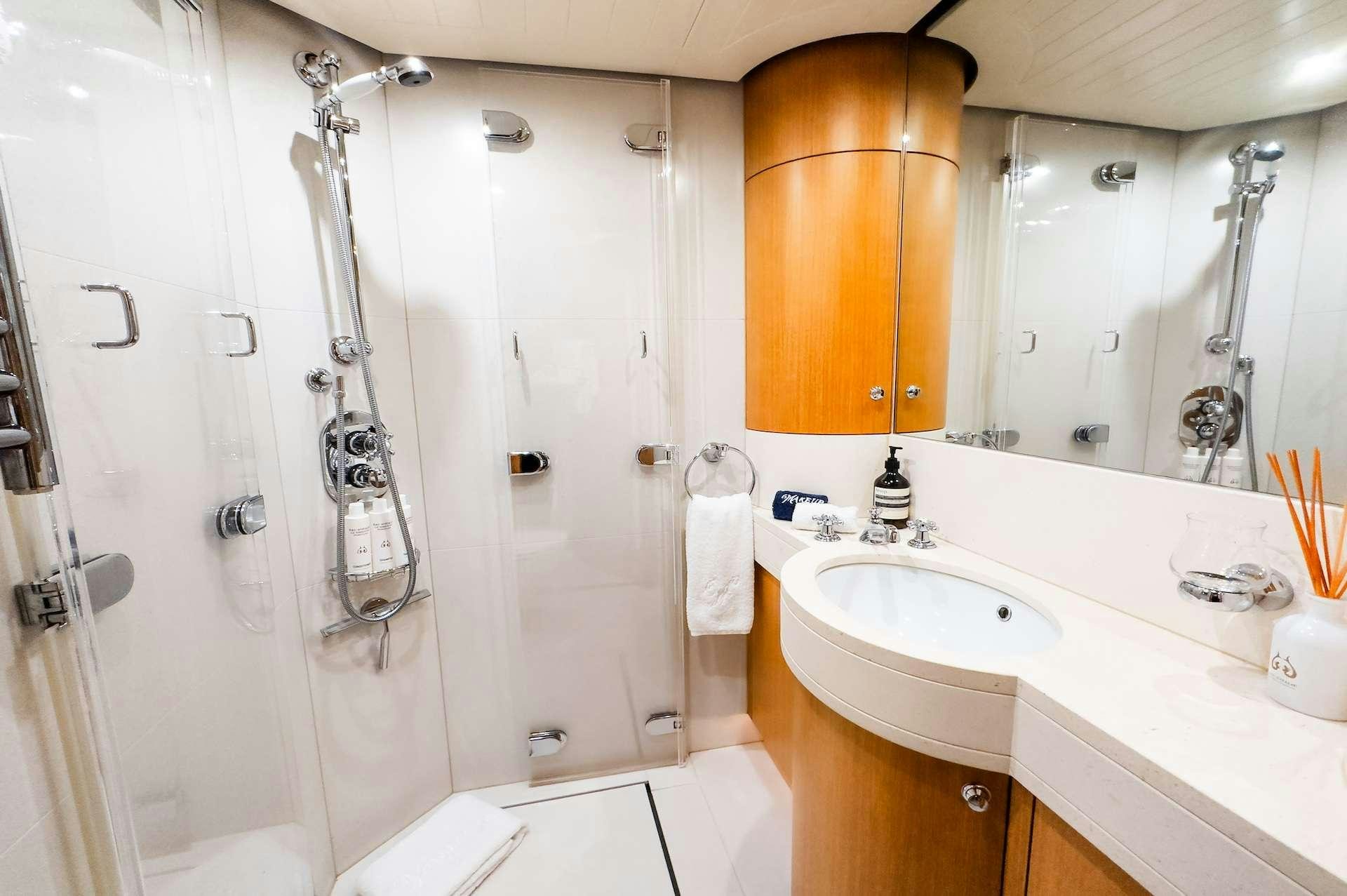 a bathroom with a shower and sink aboard WONDERLAND Yacht for Charter