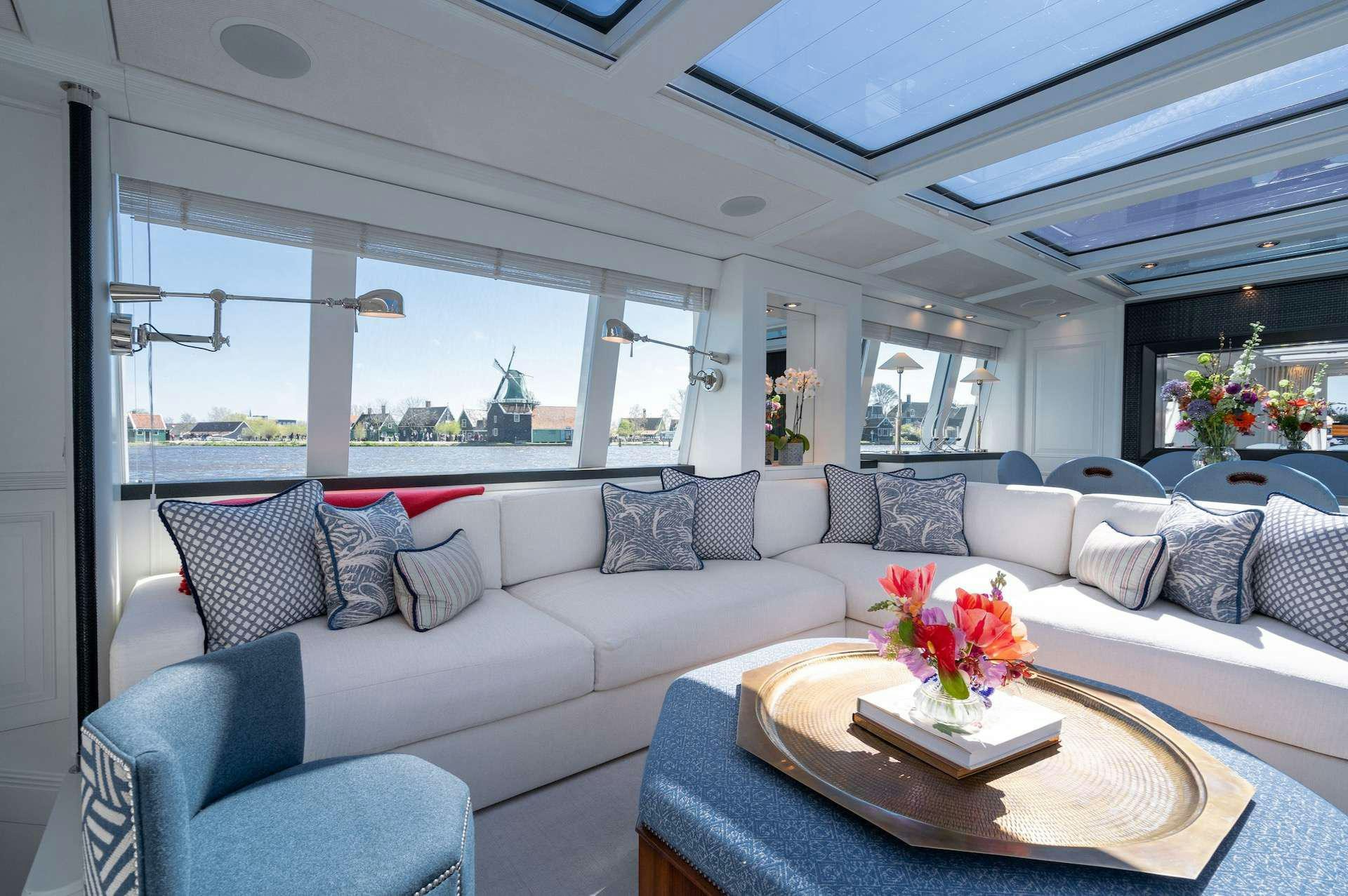 a living room with a couch and a table aboard WONDERLAND Yacht for Charter