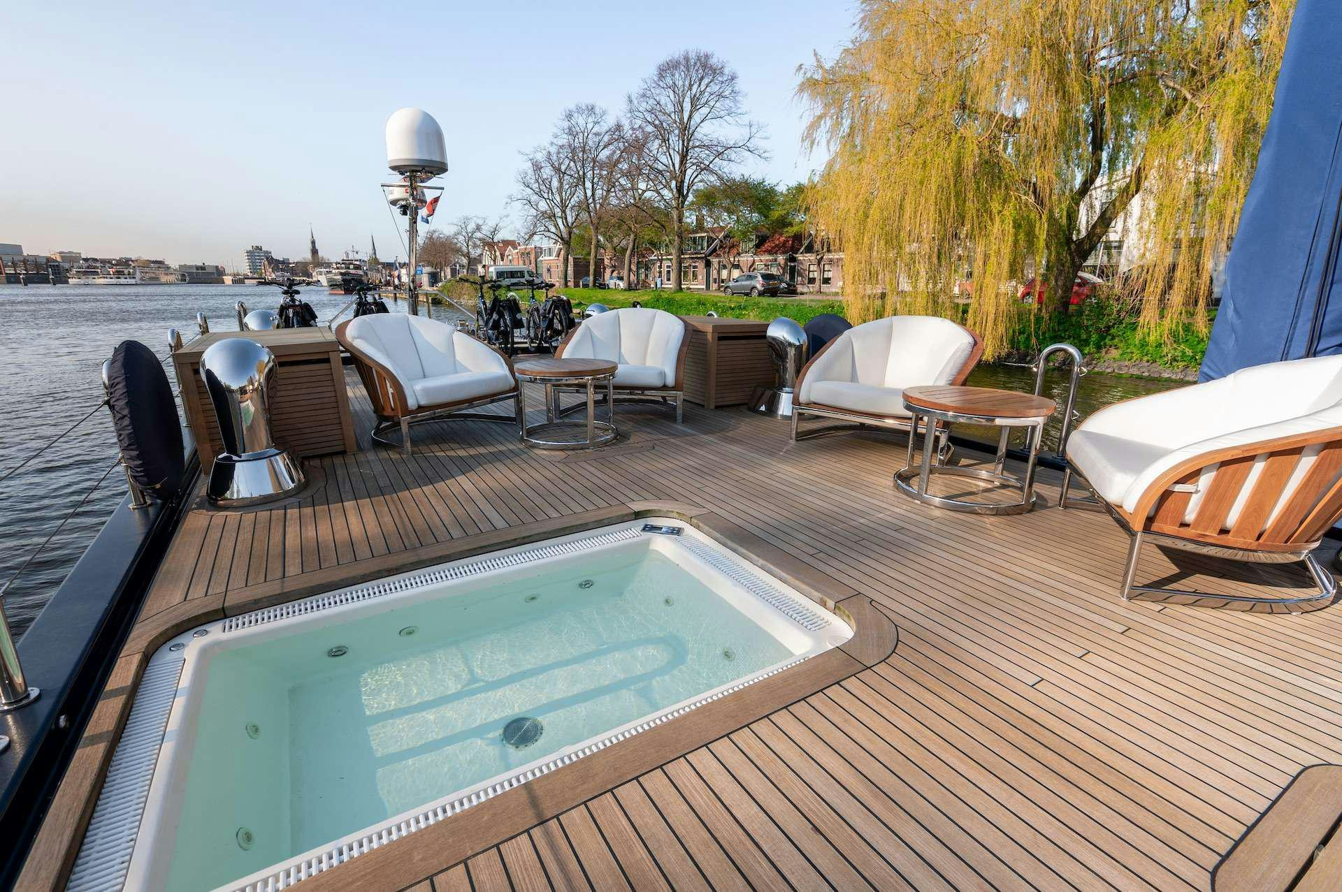 a deck with a pool and chairs aboard WONDERLAND Yacht for Charter