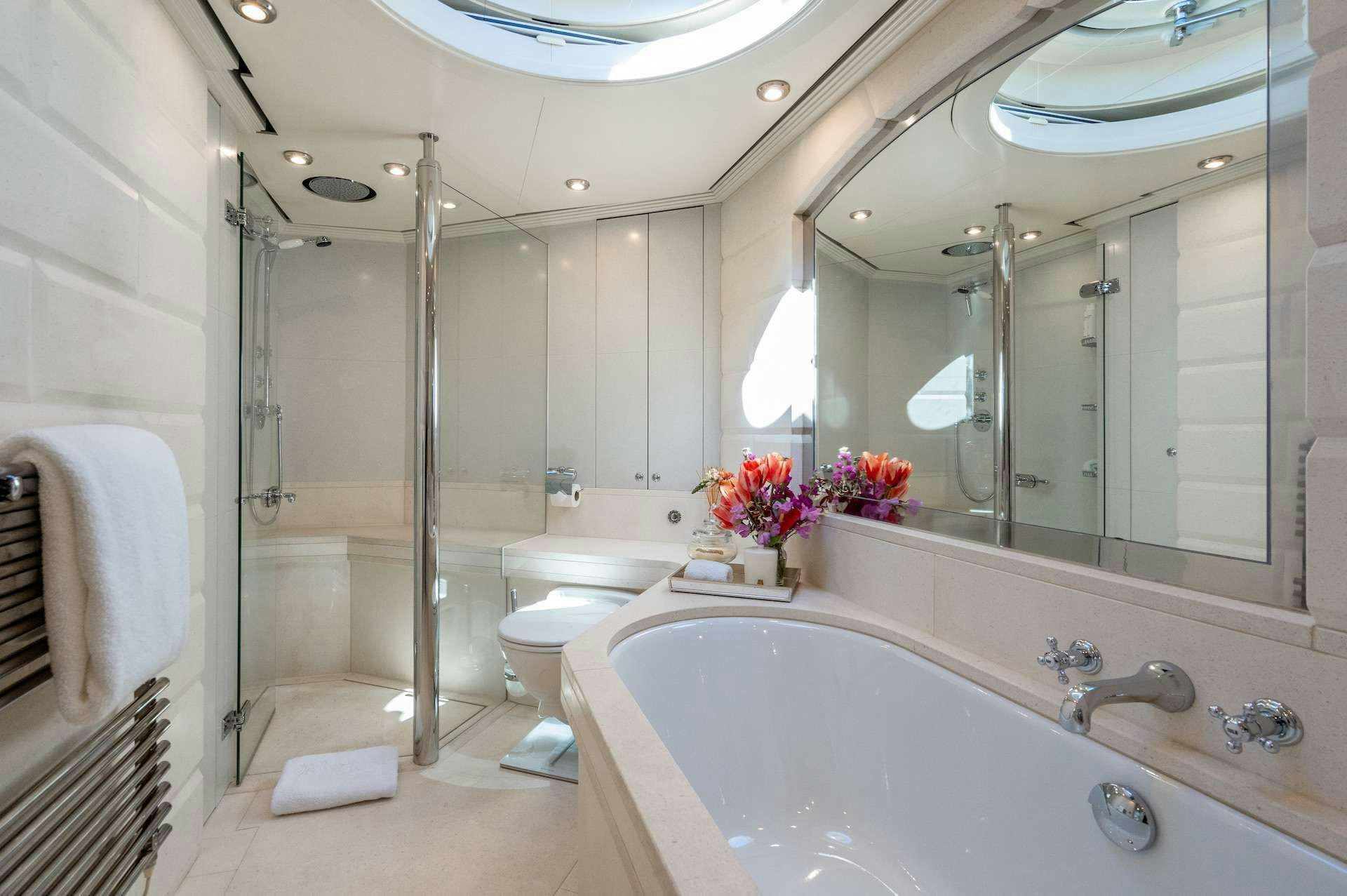 a bathroom with a glass shower aboard WONDERLAND Yacht for Charter