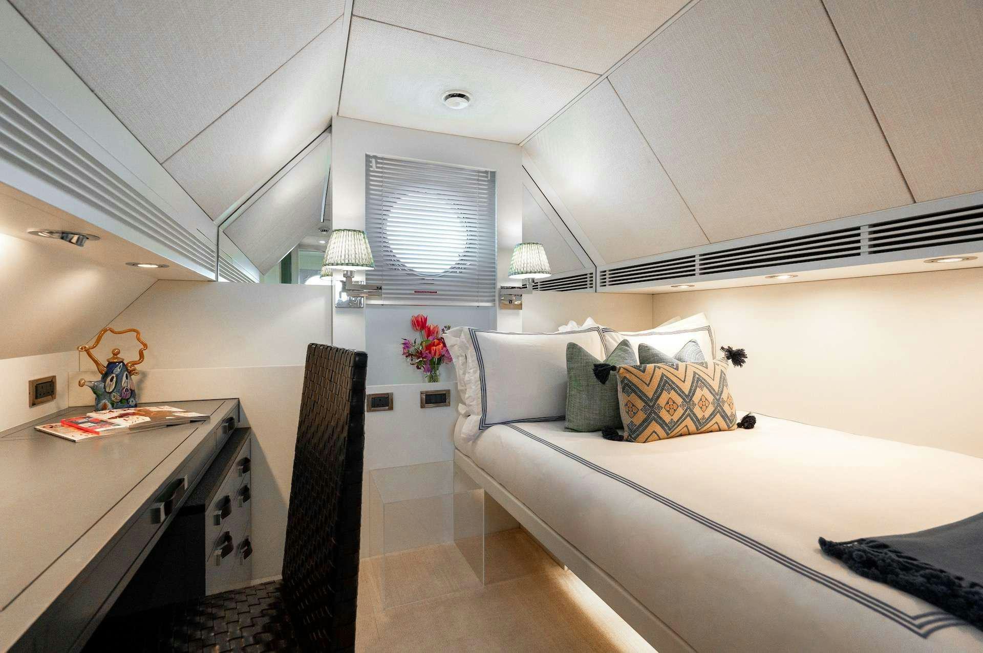 a room with a bed and a desk aboard WONDERLAND Yacht for Charter