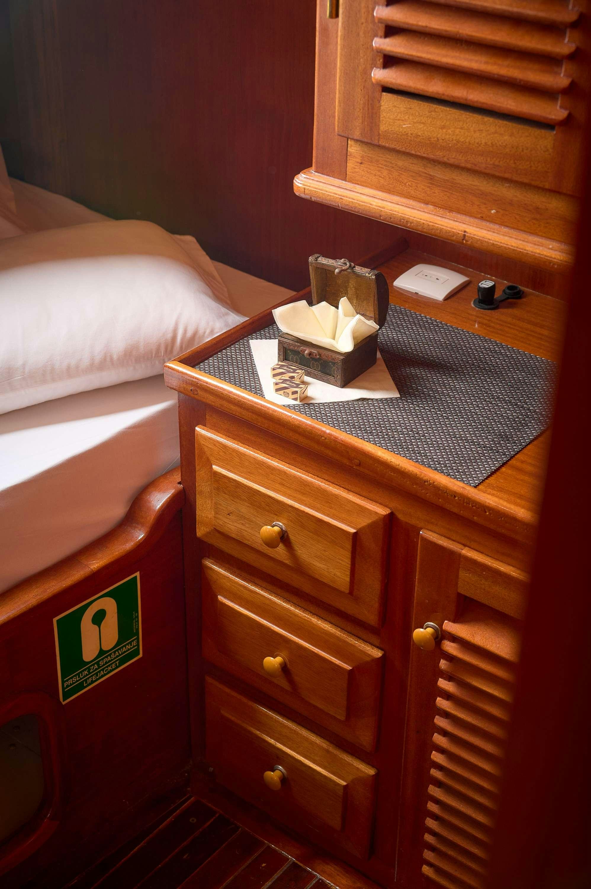 a bed with a book on it aboard AGORA Yacht for Charter