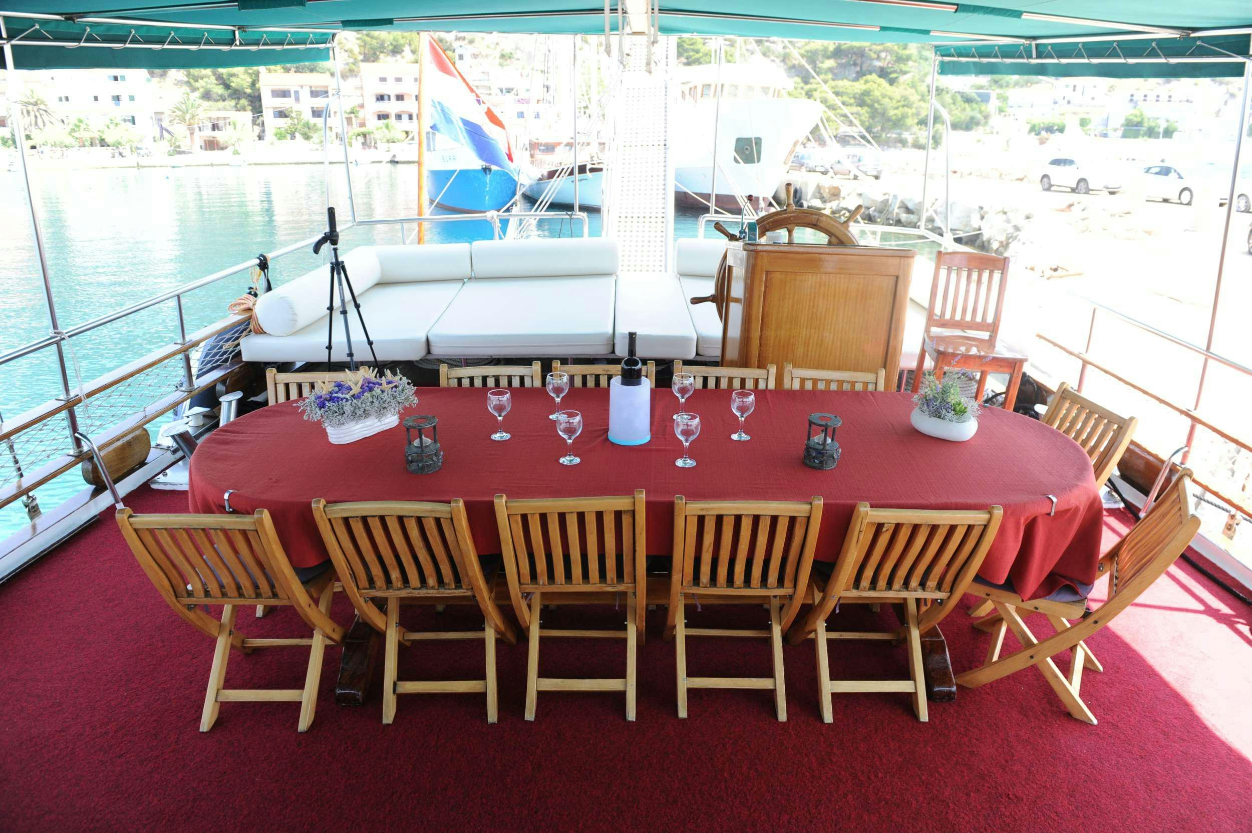 a table with chairs around it aboard AGORA Yacht for Charter