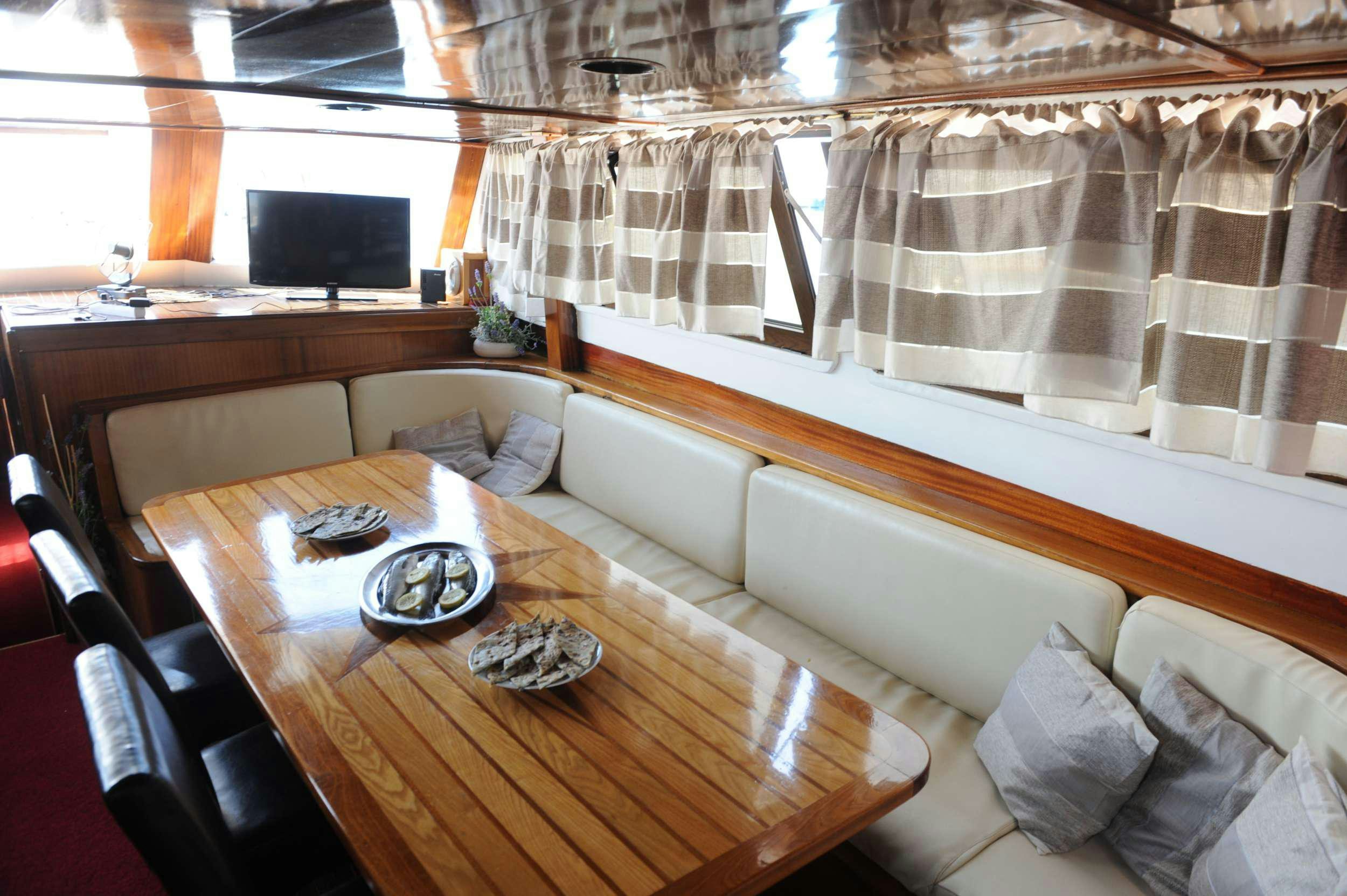 a room with a couch and a table aboard AGORA Yacht for Charter
