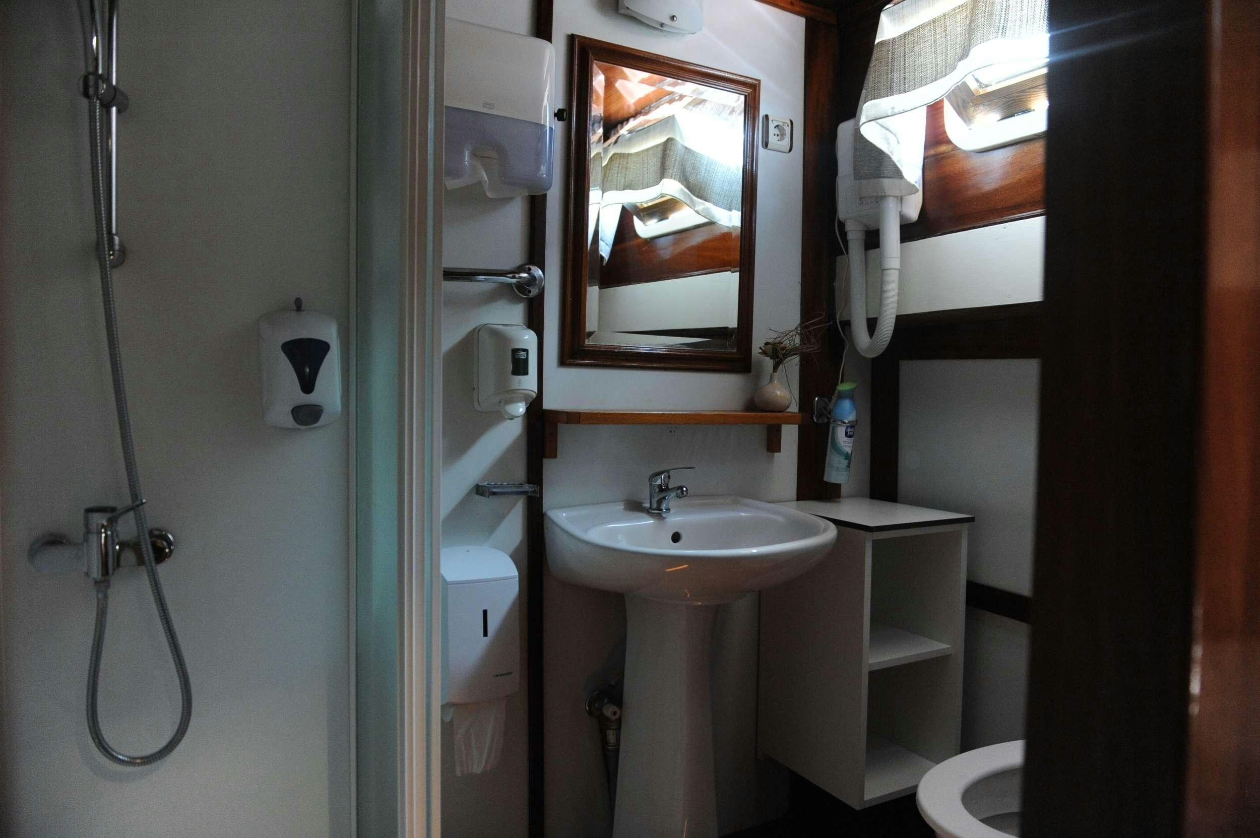 a bathroom with a sink and mirror aboard AGORA Yacht for Charter
