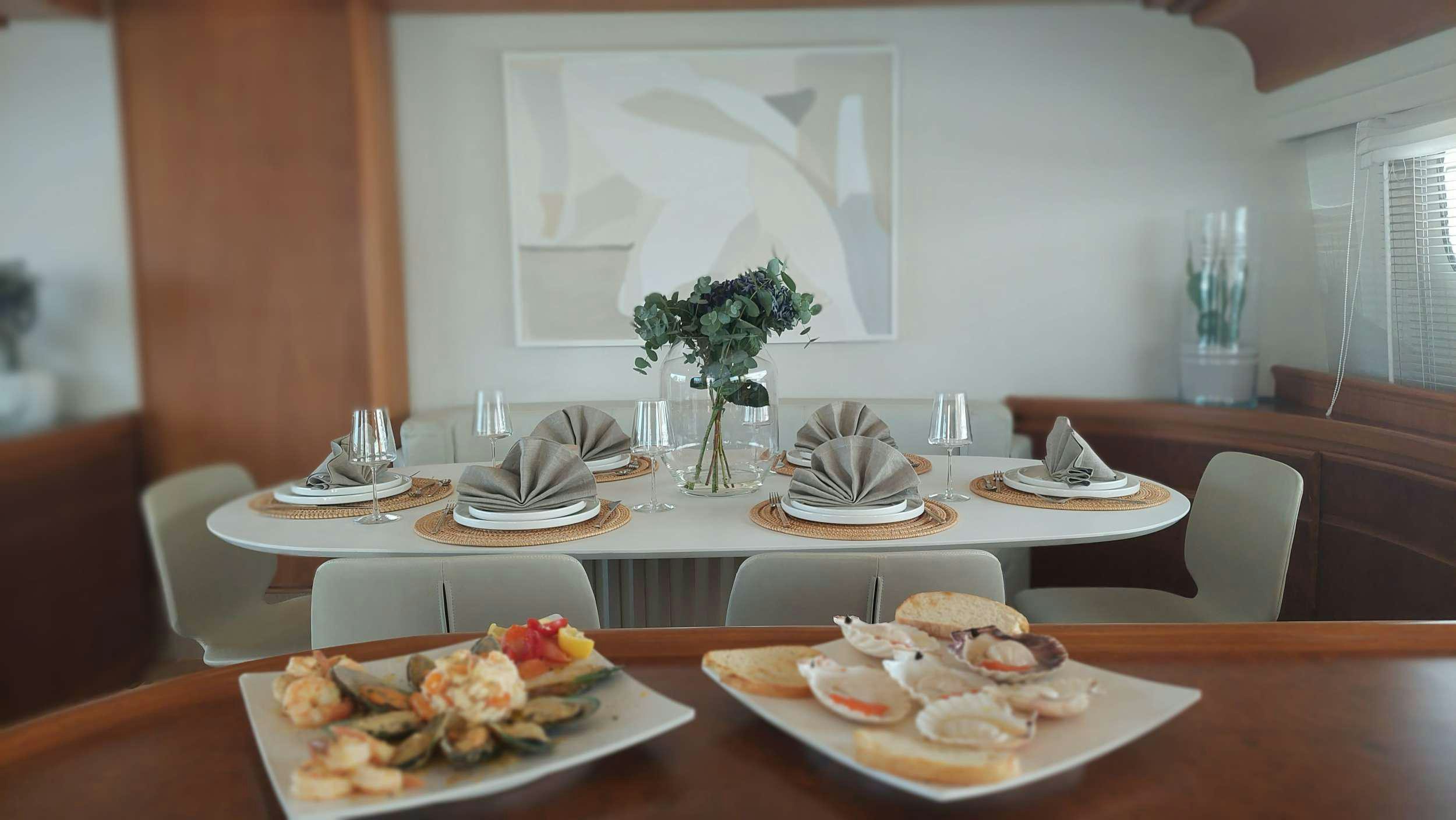 a table with plates of food aboard VA BENE Yacht for Charter