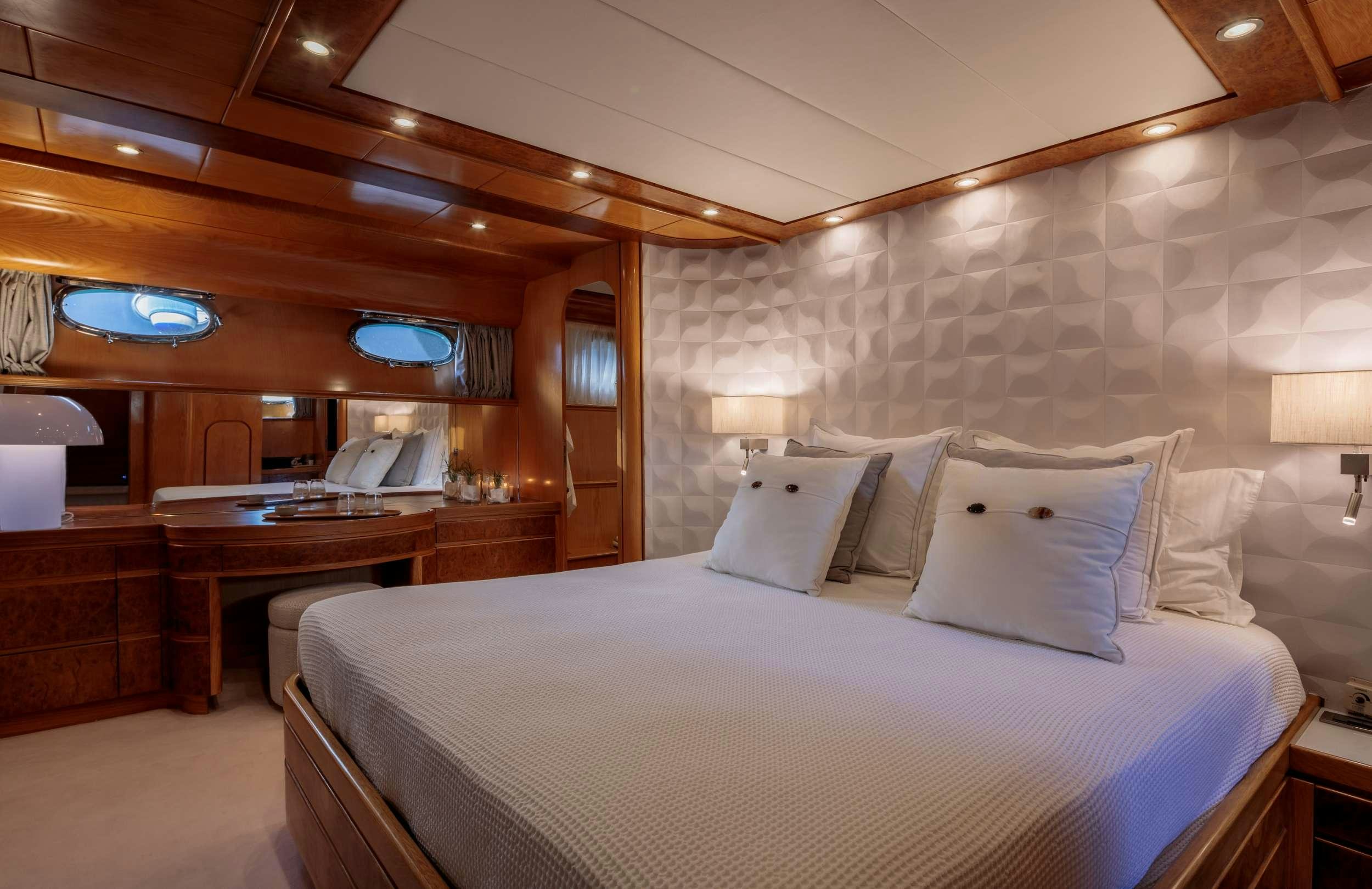 a large bed in a hotel room aboard VA BENE Yacht for Charter