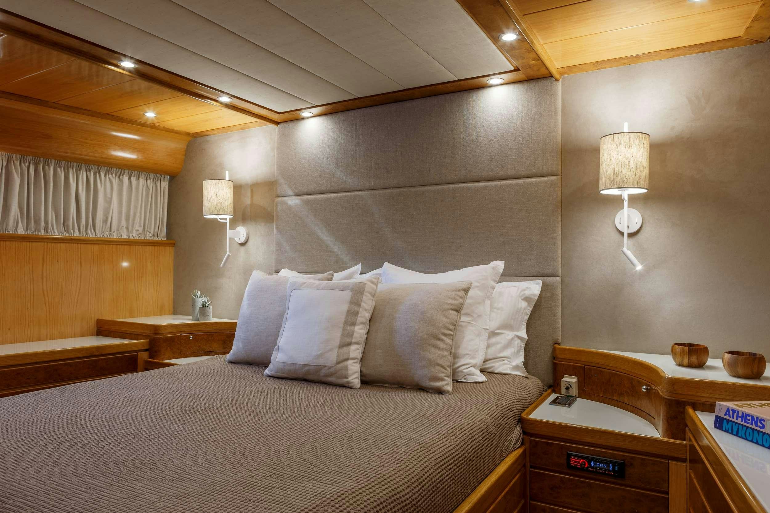 a bed with a white bed spread aboard VA BENE Yacht for Charter